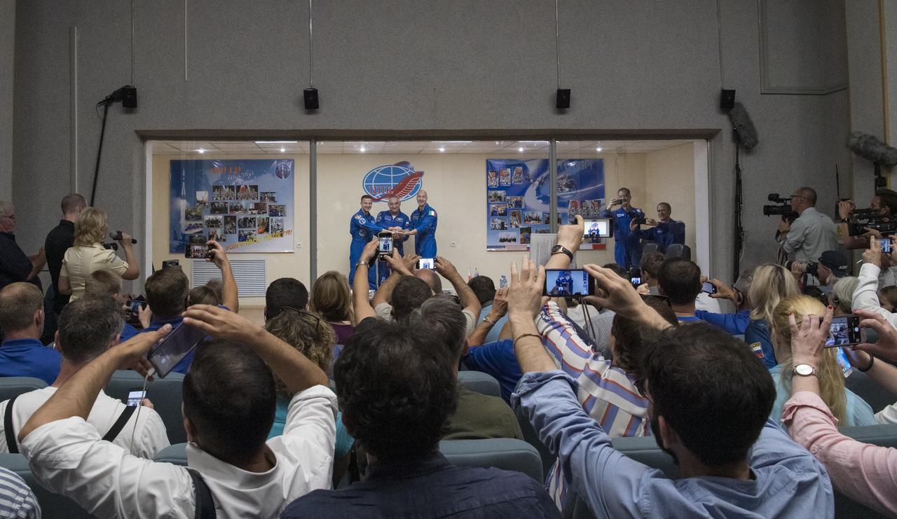 Expedition 60 flight engineer Andrew Morgan of NASA, left, Soyuz Commander Alexander Skvortsov of Roscosmos, center, and flight engineer Luca Parmitano of ESA (European Space Agency), right, pose for a picture at the conclusion of a press conference, Friday, July 19, 2019 at the Cosmonaut Hotel in Baikonur, Kazakhstan. Morgan, Skvortsov, and Parmitano are scheduled to launch to the International Space Station aboard the Soyuz MS-13 spacecraft at 12:28 p.m. Eastern time (9:28 p.m. Baikonur time) on Saturday, July 20. Photo Credit: (NASA/Joel Kowsky)