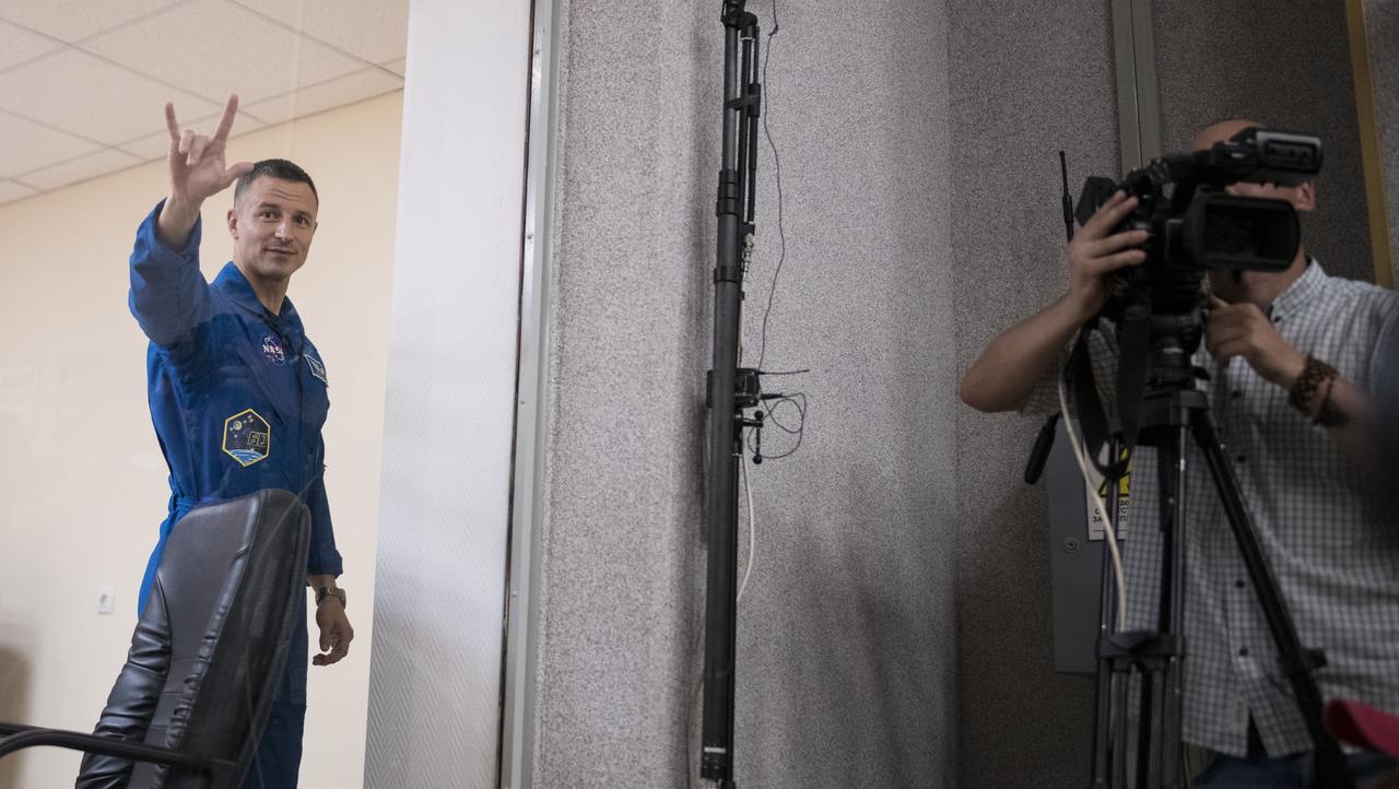 Expedition 60 flight engineer Andrew Morgan of NASA is seen in quarantine, behind glass, as he leaves at the end of a press conference, Friday, July 19, 2019 at the Cosmonaut Hotel in Baikonur, Kazakhstan. Morgan, Soyuz Commander Alexander Skvortsov of Roscosmos, and flight engineer Luca Parmitano of ESA (European Space Agency) are scheduled to launch to the International Space Station aboard the Soyuz MS-13 spacecraft at 12:28 p.m. Eastern time (9:28 p.m. Baikonur time) on Saturday, July 20. Photo Credit: (NASA/Joel Kowsky)