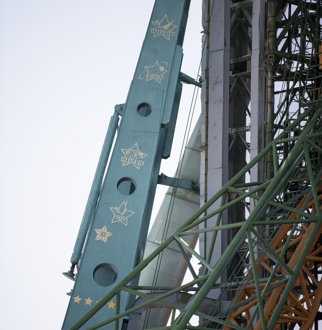 Painted markings on the service structure of Site 1 at the Baikonur Cosmodrome seen on Friday, July 19, 2019, show the milestones accomplised by launches from the historic pad. The markings commemorate the first launch from the pad on May 15, 1957, the launch of Sputnik 1 on October 4, 1957, the launch of the first human to orbit Earth, Yuri Gagarin, on April 12, 1961, and the fact that the pad has been the site of over 500 launches of various rockets since its construction. Expedition 60 Soyuz Commander Alexander Skvortsov of Roscosmos, flight engineer Andrew Morgan of NASA, and flight engineer Luca Parmitano of ESA (European Space Agency) launched from the historic pad to begin their mission to the International Space Station at 12:28 p.m. Eastern time (9:28 p.m. Baikonur time) on July 20th. Photo Credit: (NASA/Joel Kowsky)