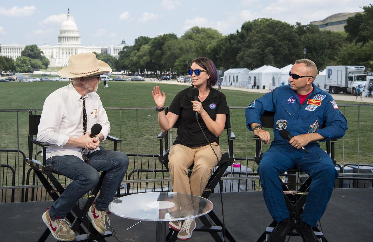 NASA Spacesuit Engineer, Lindsay Aitchison, center, speaks to Adam Savage, maker and host of Savage Builds,  along with NASA astronaut Randy Bresnik, right, during “NASA’s Giant Leaps: Past and Future," a live television program on Friday, July 19, 2019 on the National Mall in Washington. NASA and the world are recognizing the 50th anniversary of Apollo 11, in which astronauts Neil Armstrong, Michael Collins, and Buzz Aldrin crewed the first mission to land astronauts on the Moon. Photo Credit: (NASA/Aubrey Gemignani)
