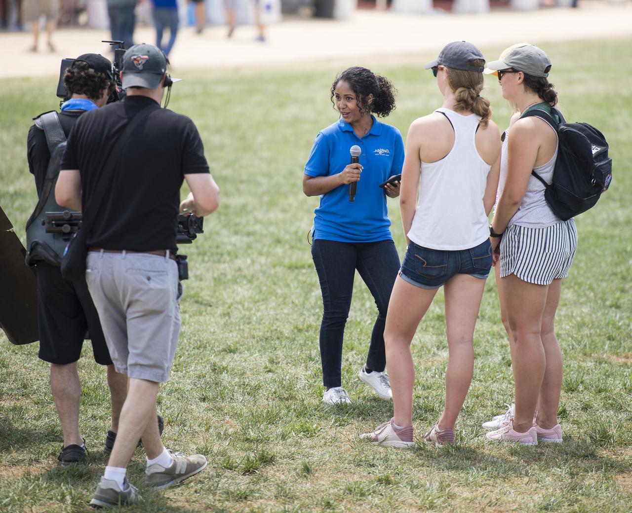 NASA Social Media Specialist, Tahira Allen, interviews visitors to the Apollo 11 50th Anniversary celebration on the National Mall during “NASA’s Giant Leaps: Past and Future," a live television program on Friday, July 19, 2019 in Washington. NASA and the world are recognizing the 50th anniversary of Apollo 11, in which astronauts Neil Armstrong, Michael Collins, and Buzz Aldrin crewed the first mission to land astronauts on the Moon. Photo Credit: (NASA/Aubrey Gemignani)