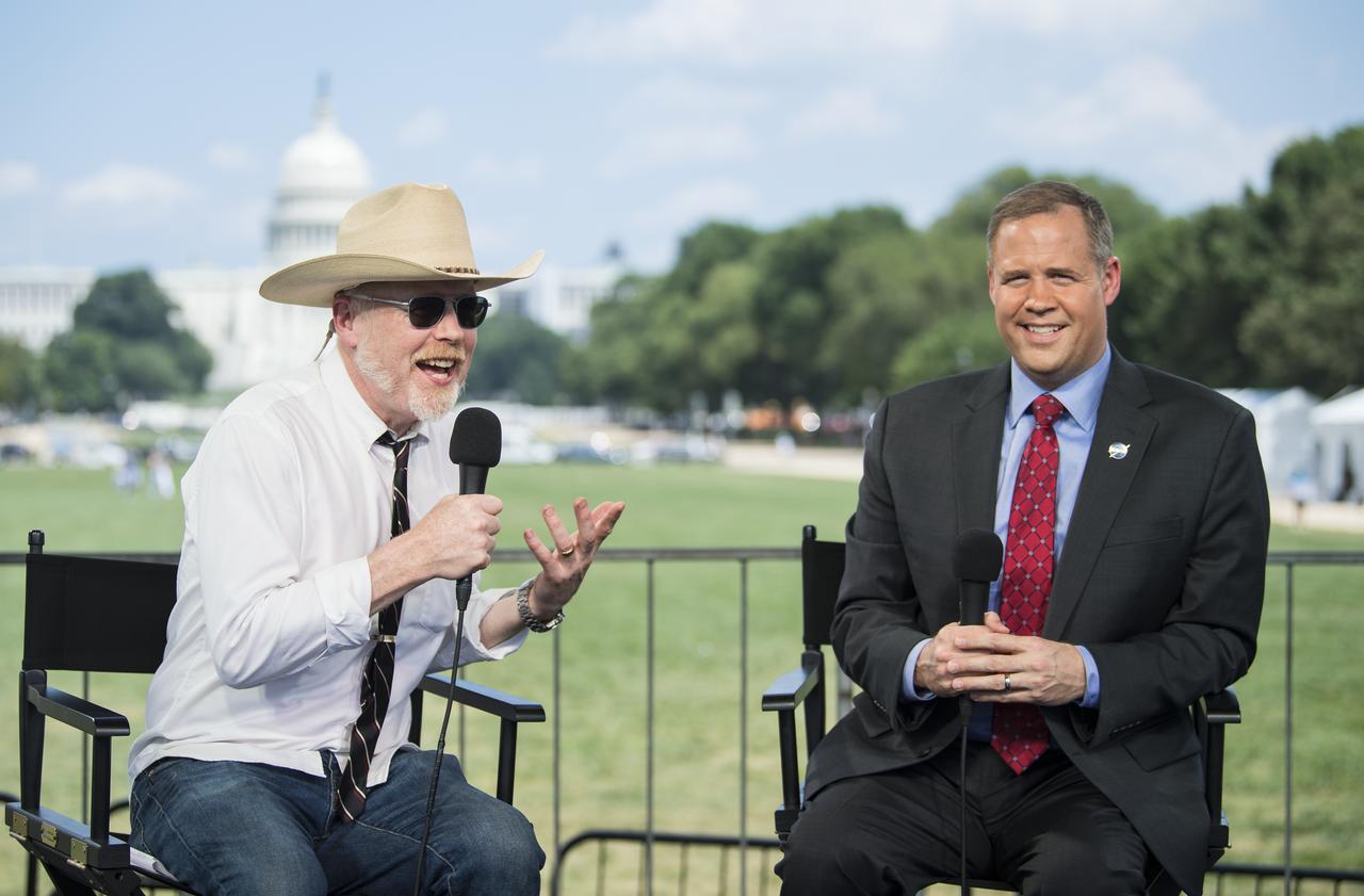 Adam Savage, maker and host of Savage Builds, left, speaks with NASA Administrator Jim Bridenstine during “NASA’s Giant Leaps: Past and Future," a live television program on Friday, July 19, 2019 on the National Mall in Washington. NASA and the world are recognizing the 50th anniversary of Apollo 11, in which astronauts Neil Armstrong, Michael Collins, and Buzz Aldrin crewed the first mission to land astronauts on the Moon. Photo Credit: (NASA/Aubrey Gemignani)