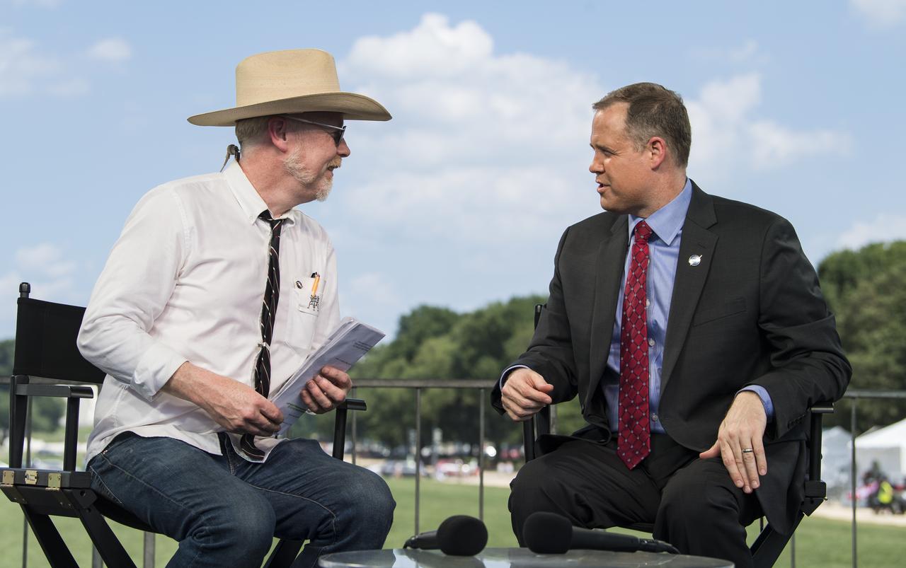 NASA Administrator Jim Bridenstine, right, speaks with Adam Savage, maker and host of Savage Builds, at the conclusion of “NASA’s Giant Leaps: Past and Future," a live television program on Friday, July 19, 2019 on the National Mall in Washington. NASA and the world are recognizing the 50th anniversary of Apollo 11, in which astronauts Neil Armstrong, Michael Collins, and Buzz Aldrin crewed the first mission to land astronauts on the Moon. Photo Credit: (NASA/Aubrey Gemignani)