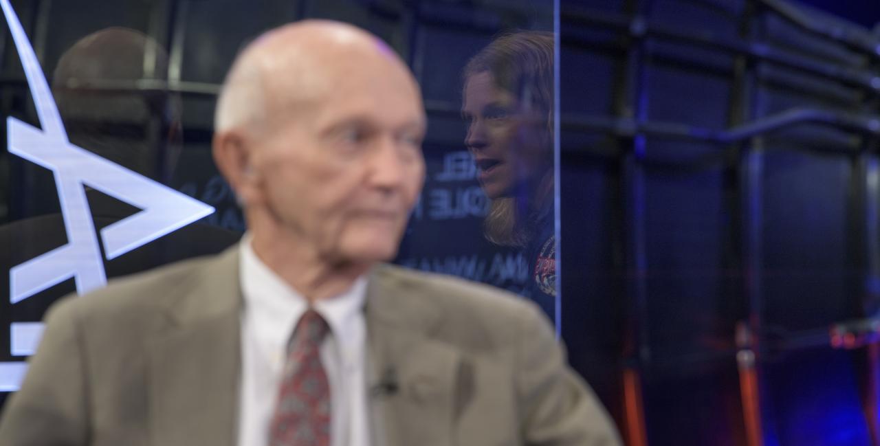 NASA astronaut candidate Zena Cardman is reflected in the glass as she talks with Apollo 11 astronaut Mike Collins during “NASA’s Giant Leaps: Past and Future," a live television program on Friday, July 19, 2019 from the Smithsonian National Air and Space Museum in Washington. NASA and the world are recognizing the 50th anniversary of Apollo 11, in which astronauts Neil Armstrong, Michael Collins, and Buzz Aldrin crewed the first mission to land astronauts on the Moon. Photo Credit: (NASA/Bill Ingalls)