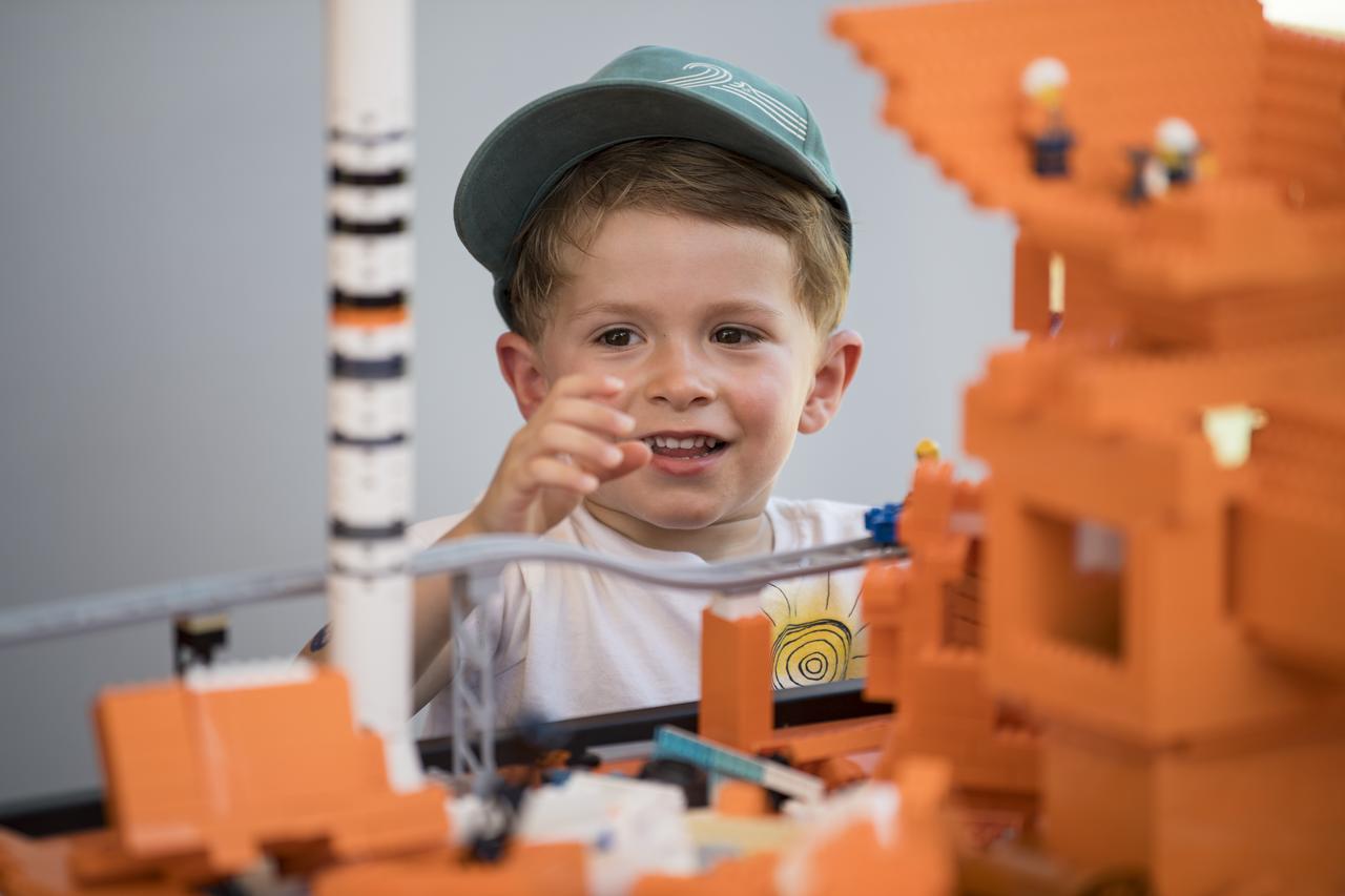 A visitor explores the LEGO exhibit at the Apollo 11 50th Anniversary celebration on the National Mall, Friday, July 19, 2019 in Washington. Apollo 11 was the first mission to land astronauts on the Moon and launched on July 16, 1969 with astronauts Neil Armstrong, Michael Collins, and Buzz Aldrin. Photo Credit: (NASA/Aubrey Gemignani)