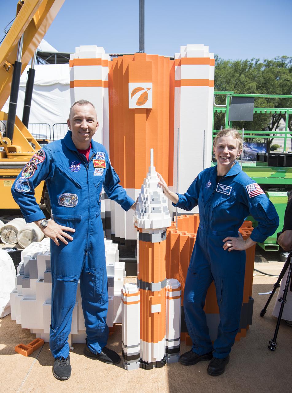 NASA astronaut Randy Bresnik, left, and NASA astronaut candidate, Zena Cardman, pose for a photo with the soon to be 20 ft. model of the Space Launch System (SLS) made out of LEGOs, at the Apollo 11 50th Anniversary celebration on the National Mall, Friday, July 19, 2019 in Washington. Apollo 11 was the first mission to land astronauts on the Moon and launched on July 16, 1969 with astronauts Neil Armstrong, Michael Collins, and Buzz Aldrin. Photo Credit: (NASA/Aubrey Gemignani)