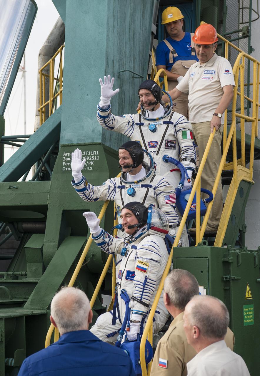 Expedition 60 flight engineer Luca Parmitano of ESA (European Space Agency), top, flight engineer Andrew Morgan of NASA, middle, and Soyuz Commander Alexander Skvortsov of Roscosmos, bottom, wave farewell prior to boarding the Soyuz MS-13 spacecraft for launch, Saturday, July 20, 2019 at the Baikonur Cosmodrome in Kazakhstan. Parmitano, Morgan, and Skvortsov will join fellow Expedition 60 crew members Commander Alexey Ovchinin of Roscosmos and NASA flight engineers Nick Hague and Christina Koch, who have been aboard the International Space Station since March. Photo Credit: (NASA/Joel Kowsky)