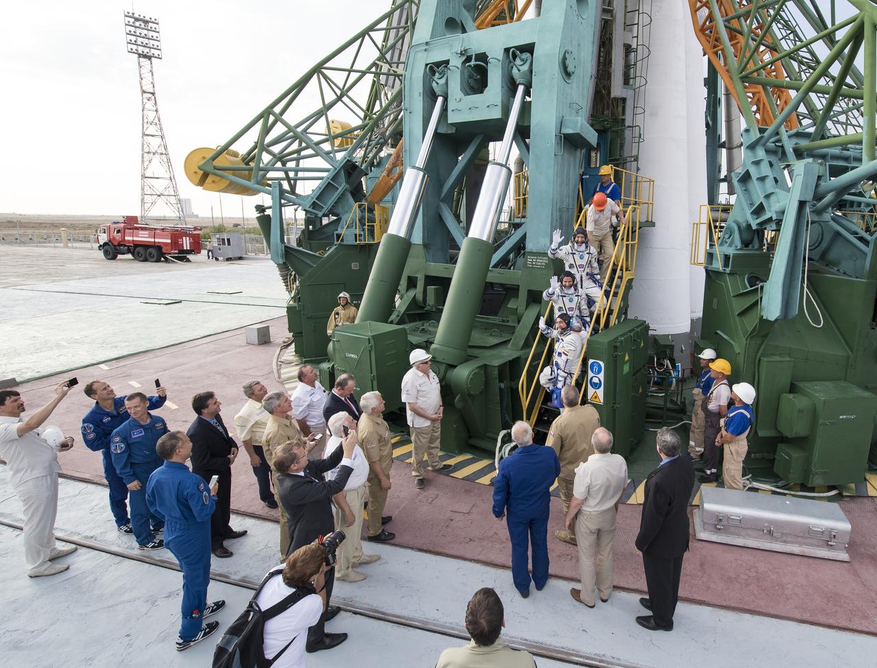 Expedition 60 flight engineer Luca Parmitano of ESA (European Space Agency), top, flight engineer Andrew Morgan of NASA, middle, and Soyuz Commander Alexander Skvortsov of Roscosmos, bottom, wave farewell prior to boarding the Soyuz MS-13 spacecraft for launch, Saturday, July 20, 2019 at the Baikonur Cosmodrome in Kazakhstan. Parmitano, Morgan, and Skvortsov will join fellow Expedition 60 crew members Commander Alexey Ovchinin of Roscosmos and NASA flight engineers Nick Hague and Christina Koch, who have been aboard the International Space Station since March. Photo Credit: (NASA/Joel Kowsky)