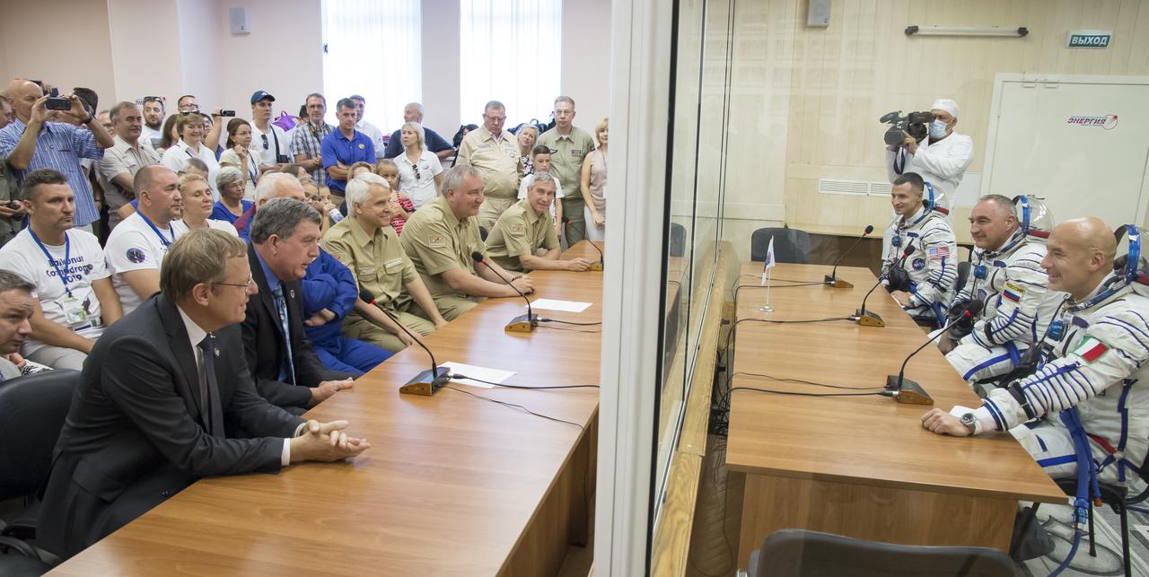 Expedition 60 flight engineer Andrew Morgan of NASA, Soyuz Commander Alexander Skvortsov of Roscosmos, and flight engineer Luca Parmitano or ESA (European Space Agency) speak with Roscosmos, NASA, and ESA (European Space Agency) management after having their Russian Sokol suits pressure checked in preparation for launch aboard the Soyuz MS-13 spacecraft, Saturday, July 20, 2019 at the Baikonur Cosmodrome in Kazakhstan. Launch of the Soyuz MS-13 spacecraft with Skvortsov, Morgan, and Parmitano occurred at 12:28 p.m. Eastern time (9:28 p.m. Baikonur time) on July 20 beginning their mission to the International Space Station. Photo Credit: (NASA/Victor Zelentsov)