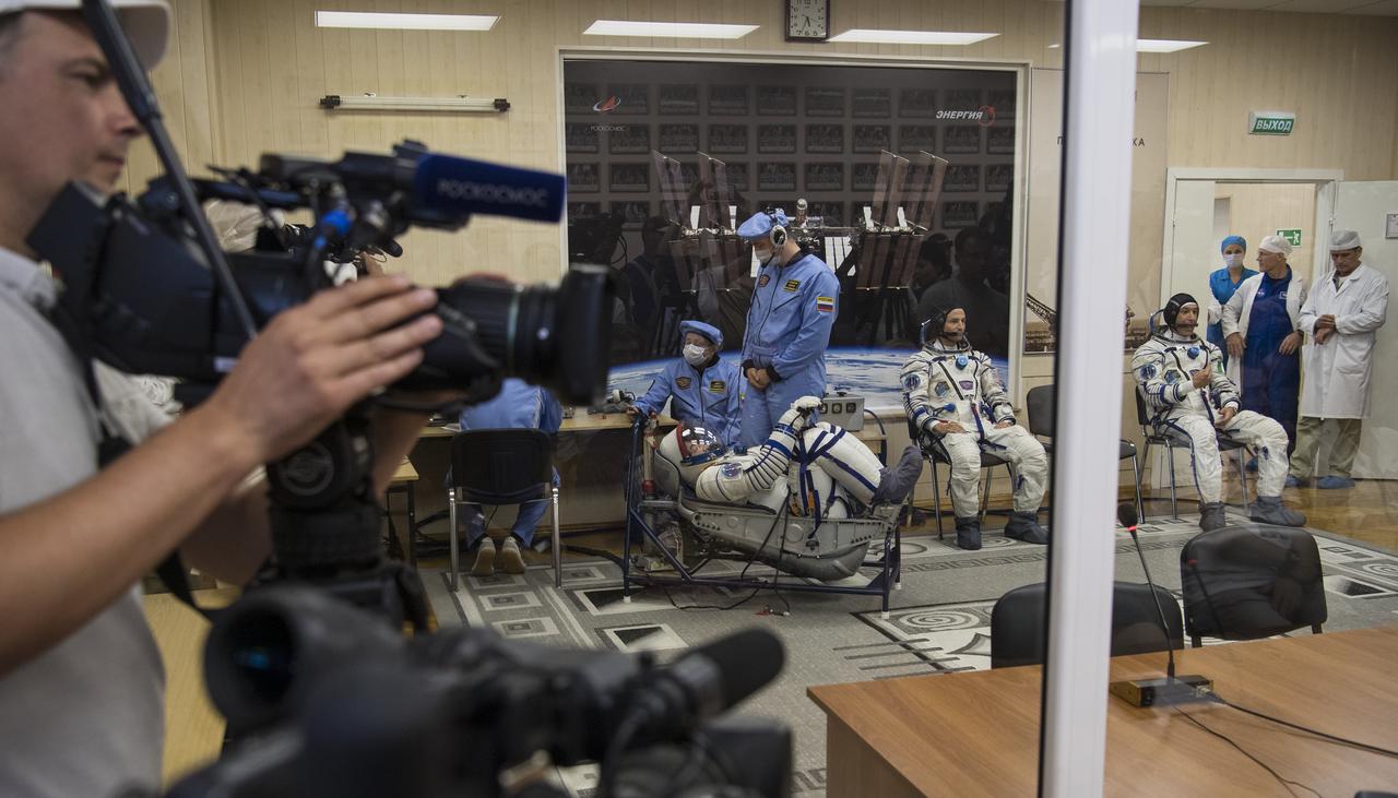 Expedition 60 Soyuz Commander Alexander Skvortsov of Roscosmos, left, has his Russian Sokol suit pressure checked in preparation for launch aboard the Soyuz MS-13 spacecraft, Saturday, July 20, 2019 at the Baikonur Cosmodrome in Kazakhstan. Skvortsov, Andrew Morgan of NASA, and Luca Parmitano of ESA (European Space Agency) launched aboard the Soyuz MS-13 spacecraft at 12:28 p.m. Eastern time (9:28 p.m. Baikonur time) on July 20 to begin their journey to the International Space Station. Photo Credit: (NASA/Joel Kowsky)
