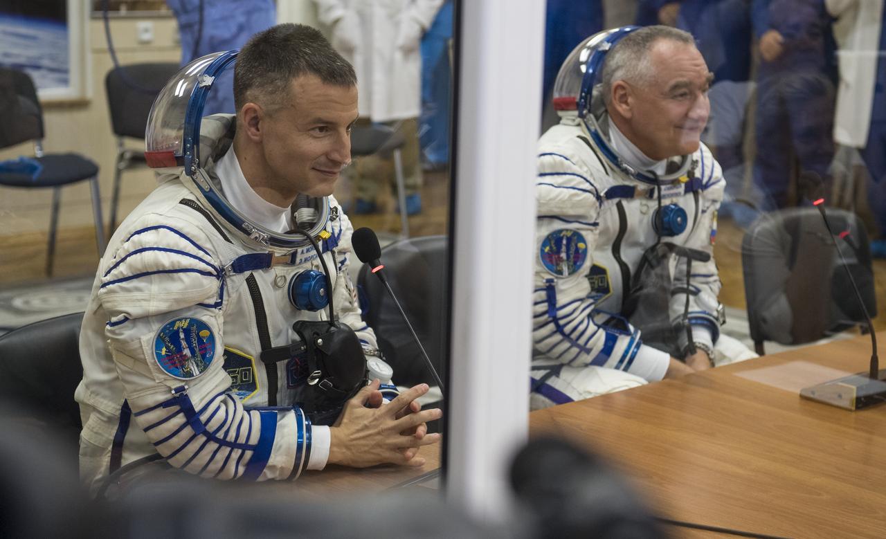 Expedition 60 flight engineer Andrew Morgan of NASA, left, and Soyuz Commander Alexander Skvortsov of Roscosmos, right, speak with family and friends after having their Russian Sokol suits pressure checked in preparation for launch aboard the Soyuz MS-13 spacecraft, Saturday, July 20, 2019 at the Baikonur Cosmodrome in Kazakhstan. Morgan, Skvortsov, and Luca Parmitano of ESA (European Space Agency) launched aboard the Soyuz MS-13 spacecraft at 12:28 p.m. Eastern time (9:28 p.m. Baikonur time) on July 20 to begin their journey to the International Space Station. Photo Credit: (NASA/Joel Kowsky)