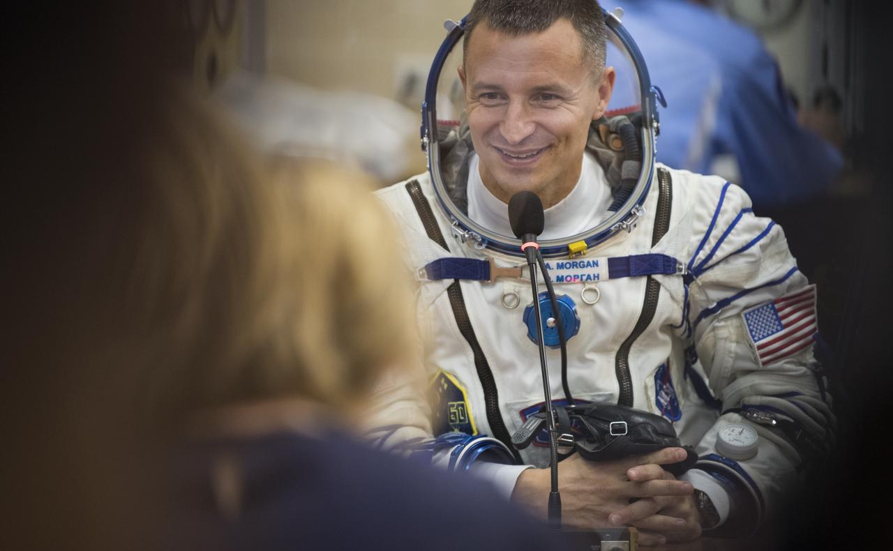 Expedition 60 flight engineer Andrew Morgan of NASA speaks with family after having his Russian Sokol suit pressure checked in preparation for launch aboard the Soyuz MS-13 spacecraft, Saturday, July 20, 2019 at the Baikonur Cosmodrome in Kazakhstan. Morgan, Alexander Skvortsov of Roscosmos, and Luca Parmitano of ESA (European Space Agency) launched aboard the Soyuz MS-13 spacecraft at 12:28 p.m. Eastern time (9:28 p.m. Baikonur time) on July 20 to begin their journey to the International Space Station. Photo Credit: (NASA/Joel Kowsky)