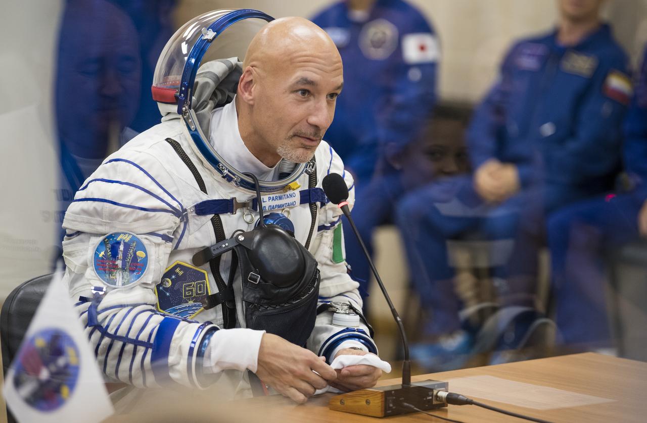 Expedition 60 flight engineer Luca Parmitano of ESA (European Space Agency) speaks with family after having his Russian Sokol suit pressure checked in preparation for launch aboard the Soyuz MS-13 spacecraft, Saturday, July 20, 2019 at the Baikonur Cosmodrome in Kazakhstan. Parmitano, Alexander Skvortsov of Roscosmos, and Andrew Morgan of NASA launched aboard the Soyuz MS-13 spacecraft at 12:28 p.m. Eastern time (9:28 p.m. Baikonur time) on July 20 to begin their journey to the International Space Station. Photo Credit: (NASA/Joel Kowsky)