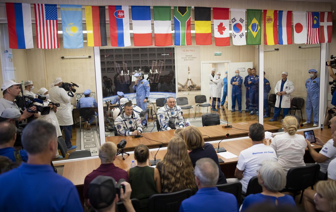 Expedition 60 flight engineer Andrew Morgan of NASA, left, and Soyuz Commander Alexander Skvortsov of Roscosmos, right, speaks with family as flight engineer Luca Parmitano of ESA (European Space Agency) has his Russian Sokol suit pressure checked in preparation for launch aboard the Soyuz MS-13 spacecraft, Saturday, July 20, 2019 at the Baikonur Cosmodrome in Kazakhstan. Morgan, Skvortsov, and Parmitano launched aboard the Soyuz MS-13 spacecraft at 12:28 p.m. Eastern time (9:28 p.m. Baikonur time) on July 20 to begin their journey to the International Space Station. Photo Credit: (NASA/Joel Kowsky)