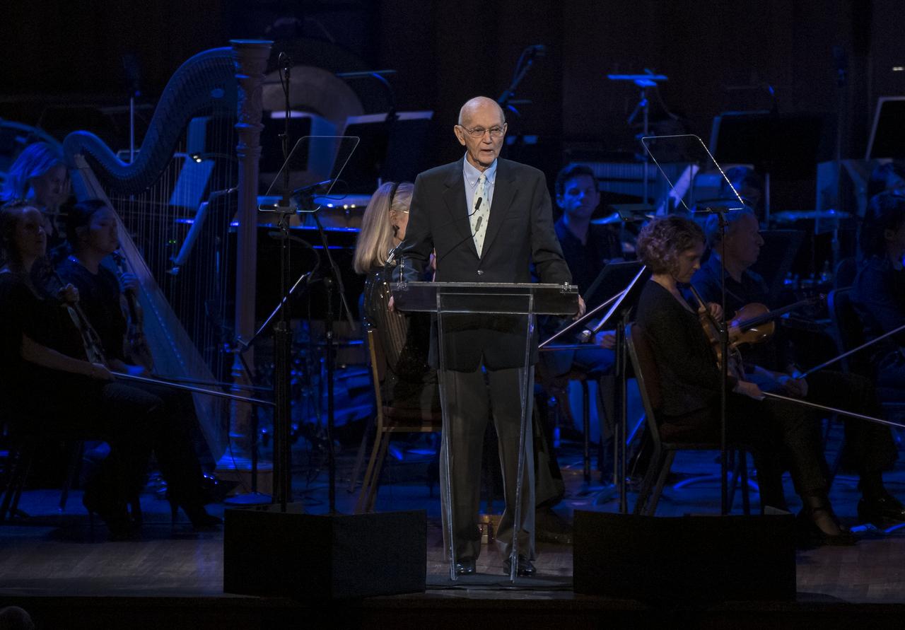 Former Apollo 11 astronaut Michael Collins speaks during the "National Symphony Orchestra Pops, Apollo 11: A 50th Anniversary, One Small Step, One Giant Leap" a program including musical acts, speakers, and images and video related to space, on Saturday, July 20, 2019 at the John F. Kennedy Center for the Performing Arts in Washington. NASA and the country are recognizing the 50th anniversary of Apollo 11, in which astronauts Neil Armstrong, Michael Collins, and Buzz Aldrin crewed the first mission to land astronauts on the Moon. Photo Credit: (NASA/Aubrey Gemignani)