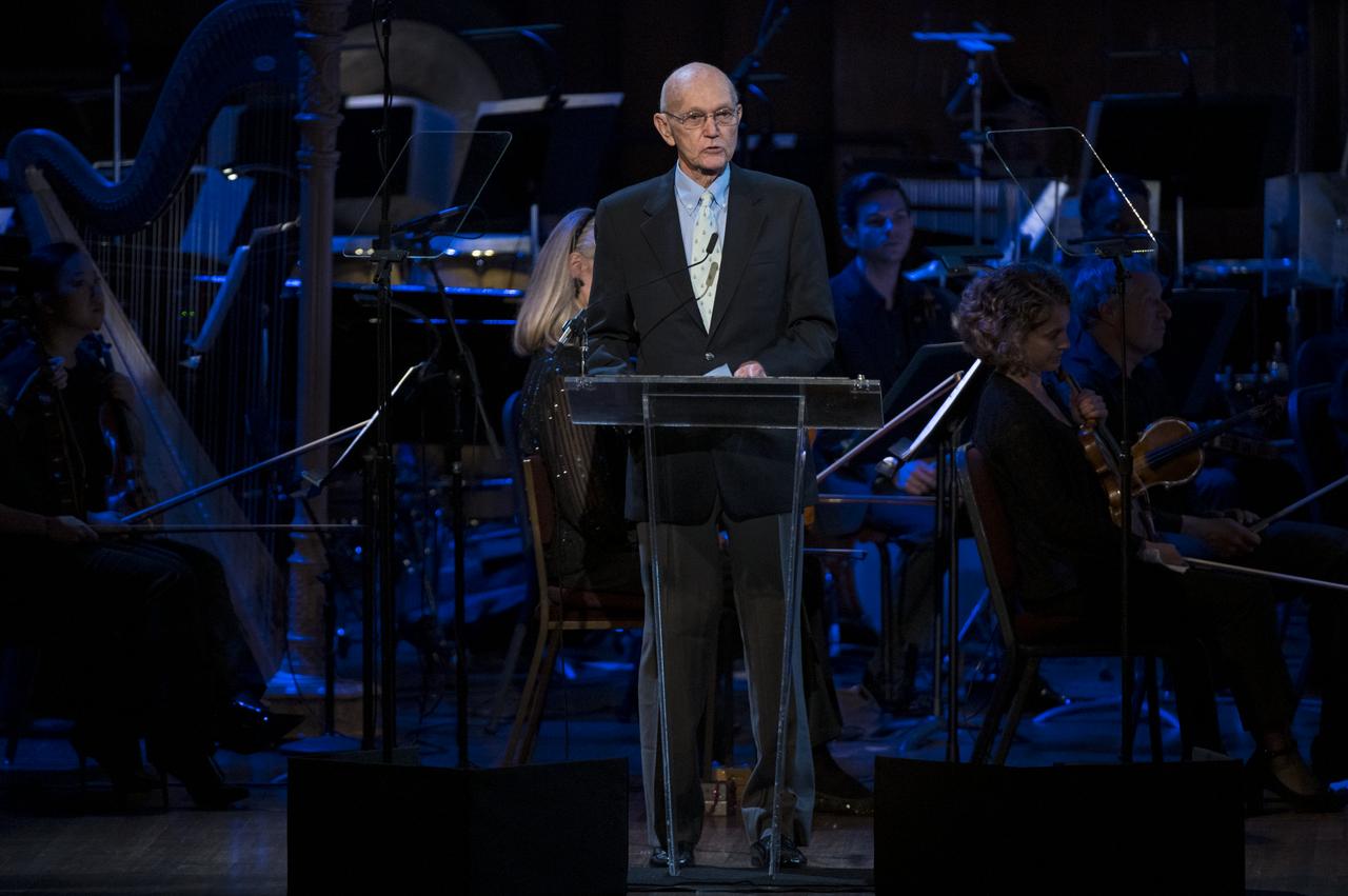 Former Apollo 11 astronaut Michael Collins speaks during the "National Symphony Orchestra Pops, Apollo 11: A 50th Anniversary, One Small Step, One Giant Leap" a program including musical acts, speakers, and images and video related to space, on Saturday, July 20, 2019 at the John F. Kennedy Center for the Performing Arts in Washington. NASA and the country are recognizing the 50th anniversary of Apollo 11, in which astronauts Neil Armstrong, Michael Collins, and Buzz Aldrin crewed the first mission to land astronauts on the Moon. Photo Credit: (NASA/Aubrey Gemignani)