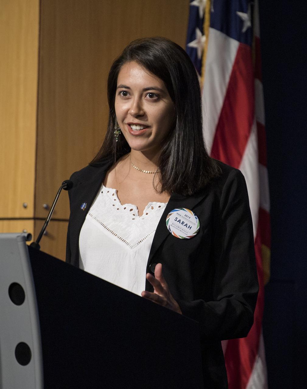 Sarah Aldama, project lead for DEVELOP Dominican Republic Disasters, speaks about mapping landslide susceptibility and exposure in the Dominican Republic using NASA's earth observation data during the 2019 Annual Earth Science Applications Showcase, Thursday, Aug. 1, 2019 at NASA Headquarters in Washington, DC. Every summer students and young professionals from NASA’s Applied Sciences’ DEVELOP National Program come to NASA Headquarters and present their research projects. DEVELOP is a training and development program where students work on Earth science research projects, mentored by science advisers from NASA and partner agencies, and extend research results to local communities. Photo Credit: (NASA/Joel Kowsky)
