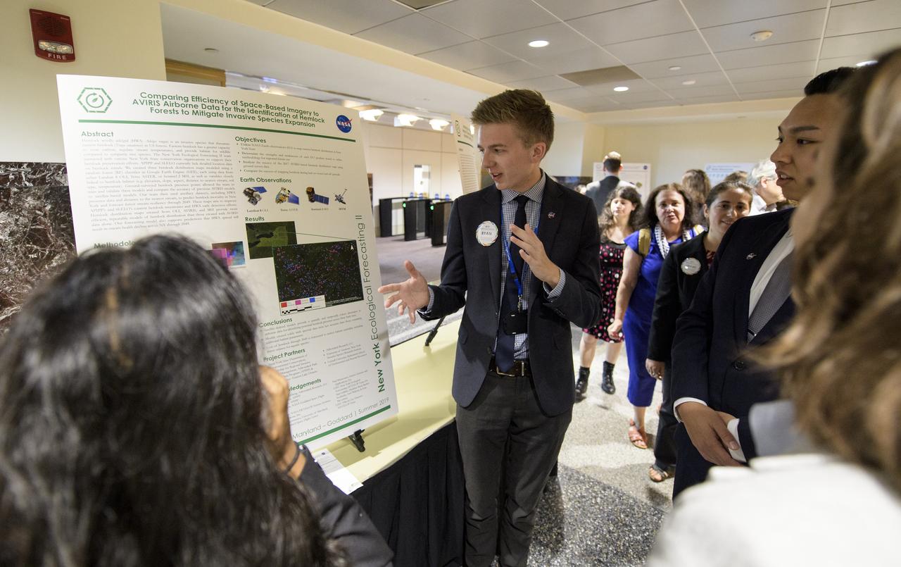 Students and young professionals discuss their projects during the 2019 Annual Earth Science Applications Showcase, Thursday, Aug. 1, 2019 at NASA Headquarters in Washington, DC. Every summer students and young professionals from NASA’s Applied Sciences’ DEVELOP National Program come to NASA Headquarters and present their research projects. DEVELOP is a training and development program where students work on Earth science research projects, mentored by science advisers from NASA and partner agencies, and extend research results to local communities. Photo Credit: (NASA/Joel Kowsky)