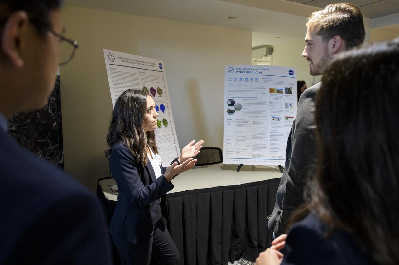 Students and young professionals discuss their projects during the 2019 Annual Earth Science Applications Showcase, Thursday, Aug. 1, 2019 at NASA Headquarters in Washington, DC. Every summer students and young professionals from NASA’s Applied Sciences’ DEVELOP National Program come to NASA Headquarters and present their research projects. DEVELOP is a training and development program where students work on Earth science research projects, mentored by science advisers from NASA and partner agencies, and extend research results to local communities. Photo Credit: (NASA/Joel Kowsky)