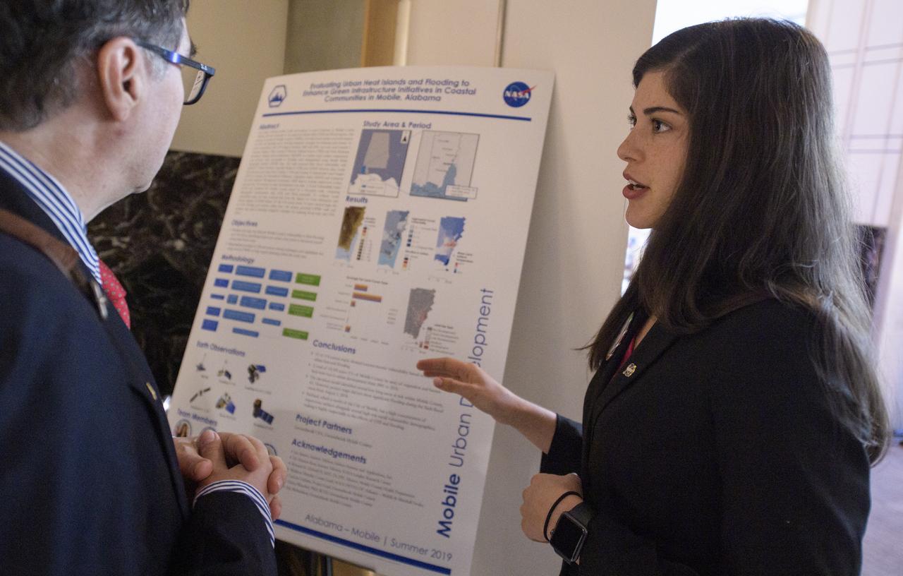 Students and young professionals discuss their projects during the 2019 Annual Earth Science Applications Showcase, Thursday, Aug. 1, 2019 at NASA Headquarters in Washington, DC. Every summer students and young professionals from NASA’s Applied Sciences’ DEVELOP National Program come to NASA Headquarters and present their research projects. DEVELOP is a training and development program where students work on Earth science research projects, mentored by science advisers from NASA and partner agencies, and extend research results to local communities. Photo Credit: (NASA/Joel Kowsky)