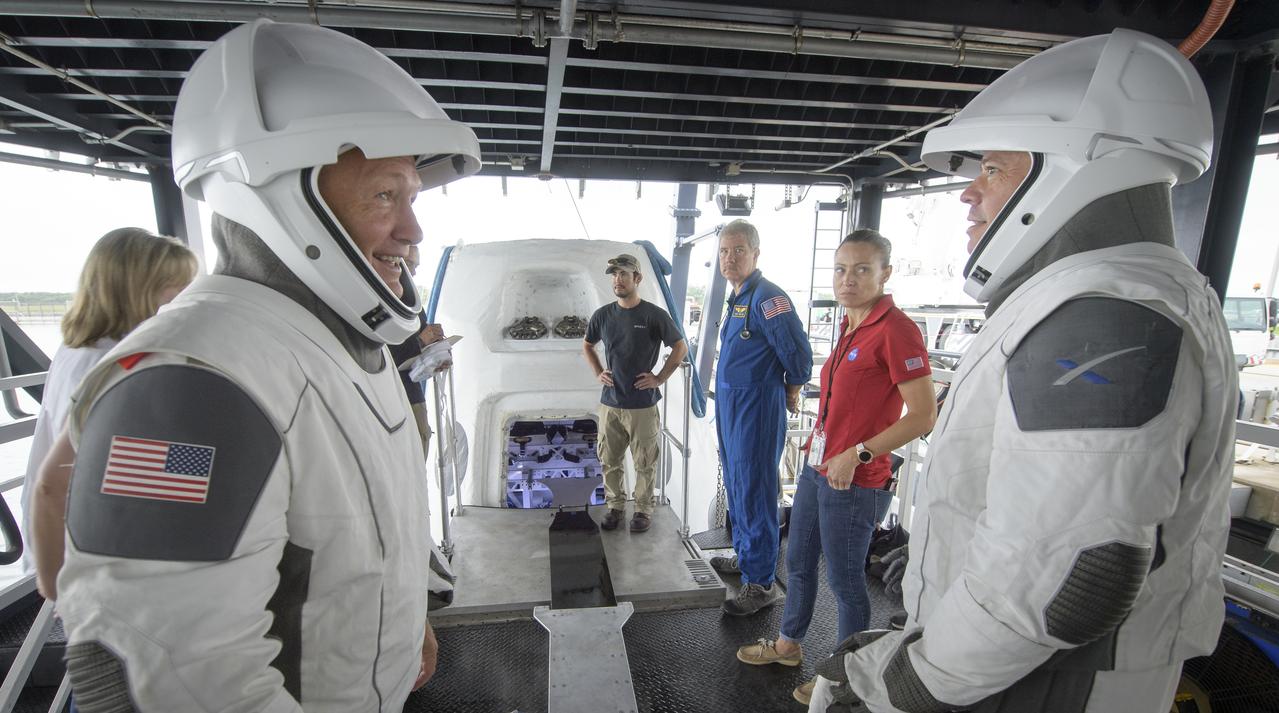 NASA astronauts Doug Hurley, left, and Bob Behnken work with teams from NASA and SpaceX to rehearse crew extraction from SpaceX’s Crew Dragon, which will be used to carry humans to the International Space Station, on August 13, 2019 at the Trident Basin in Cape Canaveral, Florida. Using the Go Searcher ship SpaceX uses to recover their spacecraft after splashdown and a mock-up of the Crew Dragon, the teams worked through the steps necessary to get NASA astronauts Doug Hurley and Bob Behnken out of the Dragon and back to dry land. Hurley and Behnken will fly to the space station aboard the Crew Dragon for the SpaceX Demo-2 mission. Photo Credit: (NASA/Bill Ingalls)