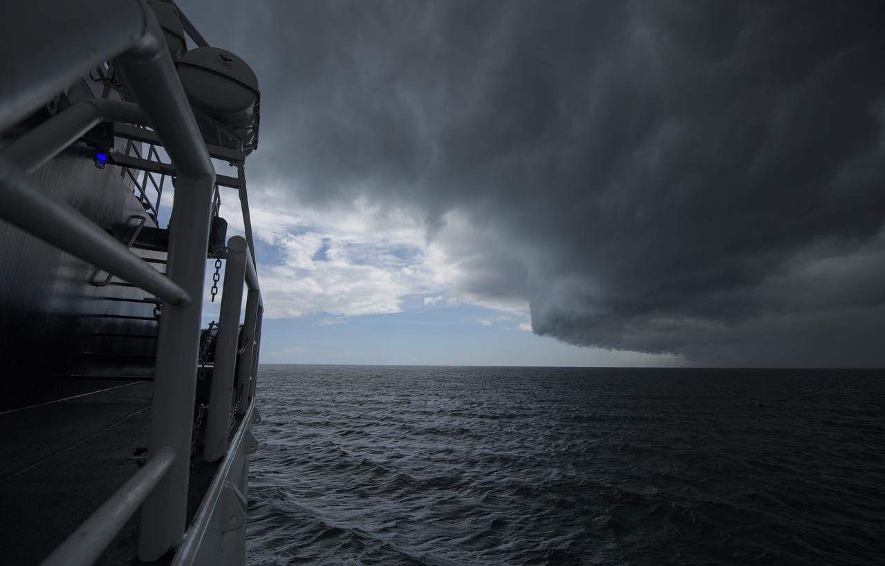 A quick moving storm passes as teams from NASA and SpaceX practice procedures for medical emergency evacuation onboard the GO Searcher ship, Friday, August 15, 2019 in the Atlantic Ocean off the coast of Cape Canaveral, Florida. SpaceX will use the GO Searcher ship during the Demo-2 mission to recover NASA astronauts returning from the International Space Station in their Crew Dragon spacecraft. Photo Credit: (NASA/Bill Ingalls)