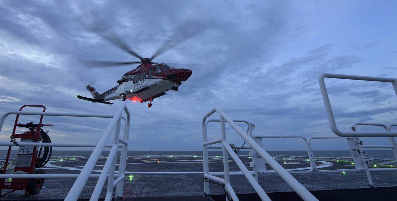 A helicopter equipped for air medical operations takes off from the GO Searcher ship as teams from NASA and SpaceX practice procedures for medical emergency evacuation, Friday, August 15, 2019 in the Atlantic Ocean off the coast of Cape Canaveral, Florida. SpaceX will use the GO Searcher ship during the Demo-2 mission to recover NASA astronauts returning from the International Space Station in their Crew Dragon spacecraft. Photo Credit: (NASA/Bill Ingalls)