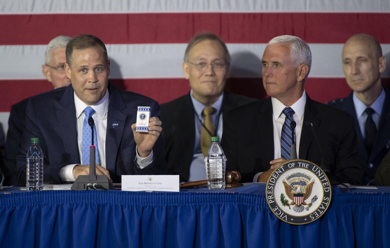 NASA Administrator Jim Bridenstine holds up a box of M&M's bearing the signature of President Donald Trump while providing an update to Vice President Mike Pence and the members of the council during the sixth meeting of the National Space Council, Tuesday, Aug. 20, 2019 at the Smithsonian National Air and Space Museum's Steven F. Udvar-Hazy Center in Chantilly, Va. Administrator Bridenstine was given the box at a recent meeting at the White House as reminder of the mission of going to the Moon & Mars. Chaired by the Vice President, the council's role is to advise the President regarding national space policy and strategy, and review the nation's long-range goals for space activities. Photo Credit: (NASA/Aubrey Gemignani)