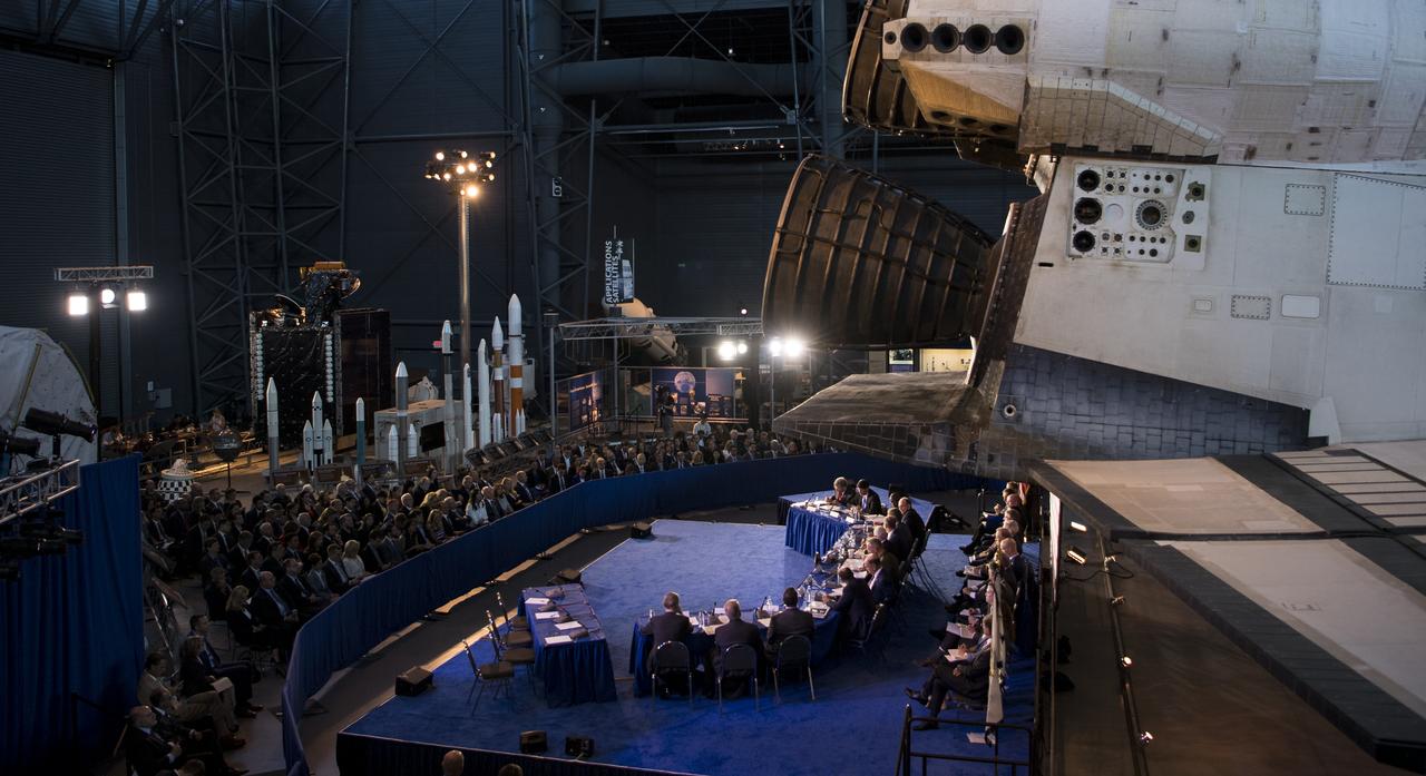 Members of the National Space Council are seen under space shuttle Discovery during the council's sixth meeting, Tuesday, Aug. 20, 2019 at the Smithsonian National Air and Space Museum's Steven F. Udvar-Hazy Center in Chantilly, Va. Chaired by Vice President Mike Pence, the council's role is to advise the President regarding national space policy and strategy, and review the nation's long-range goals for space activities. Photo Credit: (NASA/Aubrey Gemignani)
