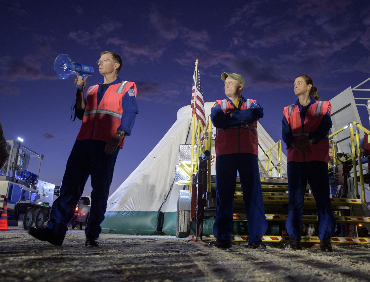 Boeing astronaut Chris Ferguson, left, and NASA astronauts Mike Fincke and Nicole Mann, along with teams from NASA, Boeing and the White Sands Missile Range, rehearse landing and crew extraction from Boeing’s CST-100 Starliner, which will be used to carry humans to the International Space Station, on Wednesday, Sept. 11, 2019 at the White Sands Missile Range outside Las Cruces, New Mexico. Using a convoy of vehicles Boeing uses to recover their spacecraft after landing and a boiler plate test article of the Starliner capsule, the teams worked through the steps necessary to safe the vehicle and get future crew members out of the Starliner to return home. Fincke, Mann and Ferguson will fly to the space station aboard the Starliner for the Boeing Crew Flight Test mission. Photo Credit: (NASA/Bill Ingalls)