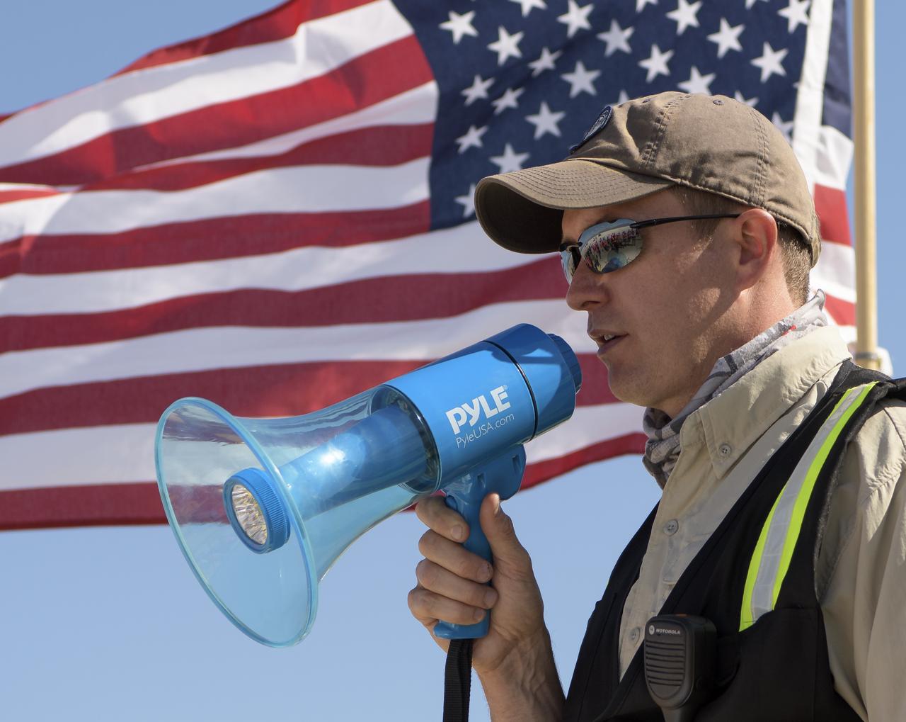 Louis Atchison chief of launch and recovery operations for Boeing Commercial Crew Program addresses teams from NASA, Boeing and the White Sands Missile Range during rehearsals for landing and crew extraction from Boeing’s CST-100 Starliner, which will be used to carry humans to the International Space Station, on Wednesday, Sept. 11, 2019 at the White Sands Missile Range outside Las Cruces, New Mexico. Using a convoy of vehicles Boeing uses to recover their spacecraft after landing and a boiler plate test article of the Starliner capsule, the teams worked through the steps necessary to safe the vehicle and get future crew members out of the Starliner to return home. NASA astronauts Mike Fincke and Nicole Mann and Boeing astronaut Chris Ferguson will fly to the space station aboard the Starliner for the Boeing Crew Flight Test mission. Photo Credit: (NASA/Bill Ingalls)