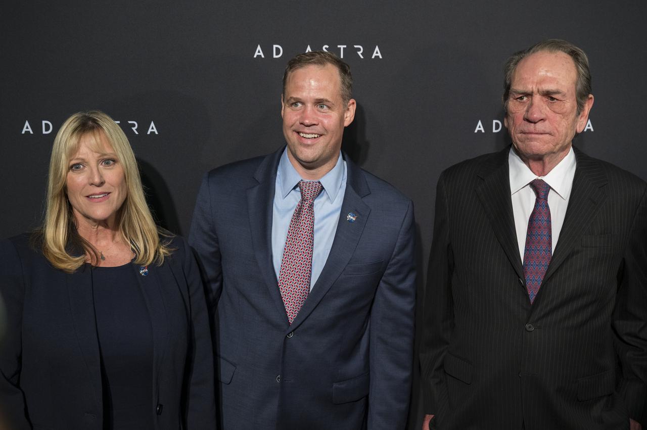 From left to right, former NASA astronaut Kay Hire, NASA Administrator Jim Bridenstine, and actor Tommy Lee Jones arrive on the red carpet for a screening of the film "Ad Astra" at National Geographic Society, Monday, September 16, 2019 in Washington. The film was produced, co-written, and directed by James Gray and stars Jones, Brad Pitt, Ruth Negga, Liv Tyler, and Donald Sutherland. Pitt stars as astronaut Roy McBride who travels deep into the solar system in hopes of solving a mystery that threatens life on Earth. Photo Credit: (NASA/Aubrey Gemignani)