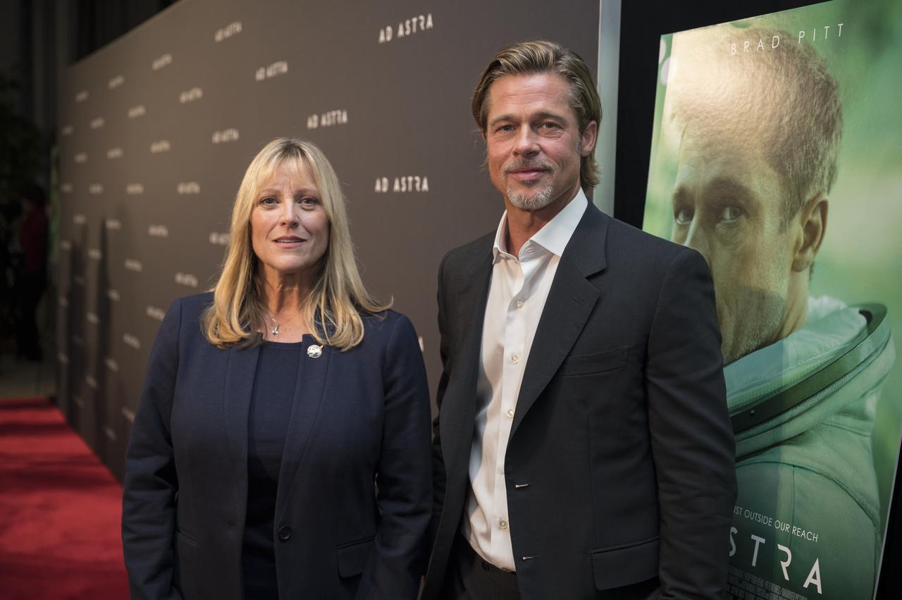 Former NASA astronaut Kay Hire poses for a photo with actor Brad Pitt, at a screening of the film "Ad Astra" at National Geographic Society, Monday, September 16, 2019 in Washington. The film stars Pitt, Tommy Lee Jones, Ruth Negga, Liv Tyler, and Donald Sutherland. Pitt stars as astronaut Roy McBride who travels deep into the solar system in hopes of solving a mystery that threatens life on Earth. Photo Credit: (NASA/Aubrey Gemignani)
