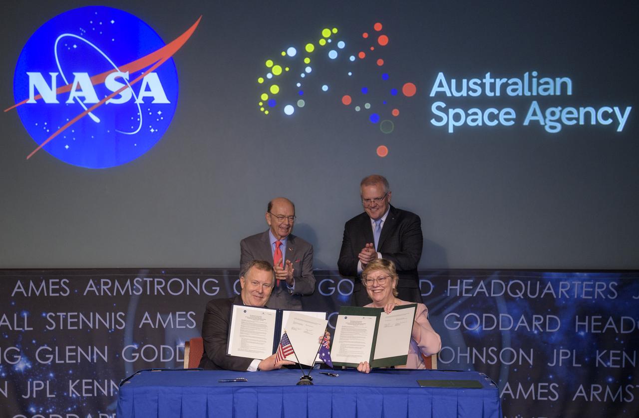 U.S. Secretary of Commerce Wilbur Ross, top left, and Australian Prime Minister Scott Morrison, top right, witness the signing of a letter of intent between NASA and the Australian Space Agency by NASA Deputy Administrator Jim Morhard, left, and Dr. Megan Clark, Head of the Australian Space Agency, right, Saturday, Sept. 21, 2019 at NASA Headquarters in Washington. NASA and the Australian Space Agency will build on over 60 years of collaboration in space exploration between the two countries and commit to expanding cooperation. Photo Credit: (NASA/Joel Kowsky)