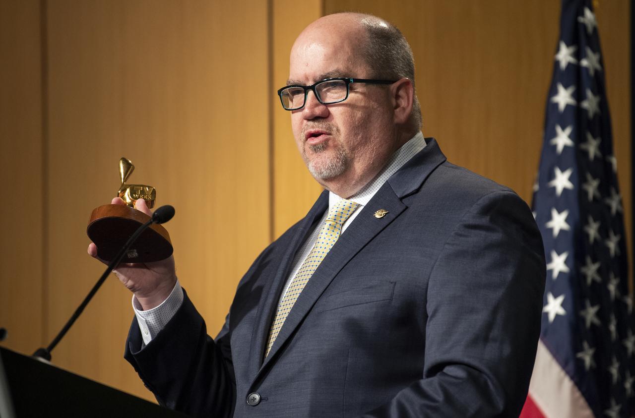 NASA Deputy Associate Administrator for Communications Bob Jacobs holds up the Logie Award presented to the crew of Apollo 11 in 1969 as he gives opening remarks prior the signing of a letter of intent between NASA and the Australian Space Agency, Saturday, Sept. 21, 2019 at NASA Headquarters in Washington. NASA and the Australian Space Agency will build on over 60 years of collaboration in space exploration between the two countries and commit to expanding cooperation. Photo Credit: (NASA/Joel Kowsky)