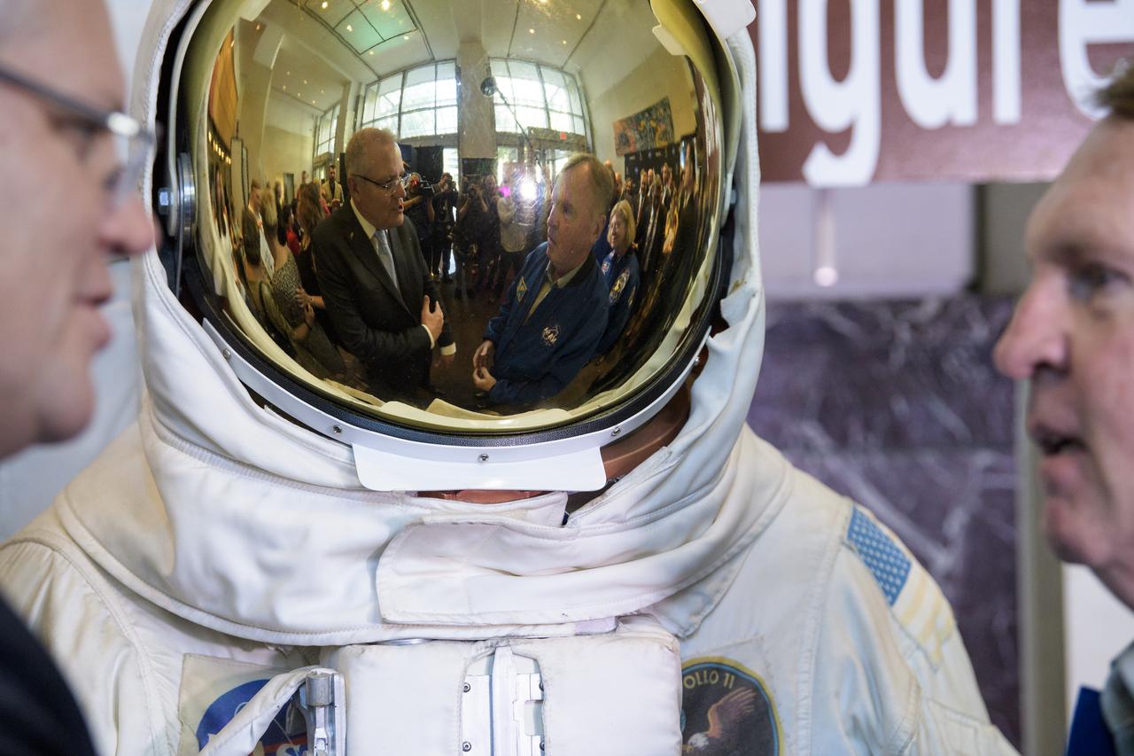 Australian Prime Minister Scott Morrison, left, and former NASA astronaut Andy Thomas, right, are reflected in the visor of a spacesuit replica as they talk following the signing of a letter of intent between NASA and the Australian Space Agency, Saturday, Sept. 21, 2019 at NASA Headquarters in Washington. NASA and the Australian Space Agency will build on over 60 years of collaboration in space exploration between the two countries and commit to expanding cooperation. Photo Credit: (NASA/Joel Kowsky)
