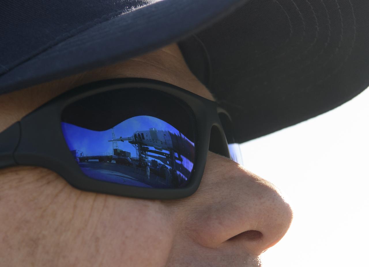The Soyuz rocket is reflected in the glasses of Expedition 61 backup crew member Thomas Marshburn of NASA shortly after it was rolled out by train to the launch pad, Monday, Sept. 23, 2019 at the Baikonur Cosmodrome in Kazakhstan. Expedition 61 crewmembers Jessica Meir of NASA and Oleg Skripochka of Roscosmos, and spaceflight participant Hazzaa Ali Almansoori of the United Arab Emirates will launch September 25th on the Soyuz MS-15 spacecraft from the Baikonur Cosmodrome to the International Space Station. Photo Credit: (NASA/Bill Ingalls)