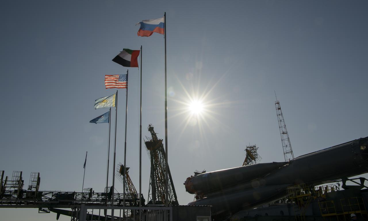 The flags of Russia, United Arab Emirates, United States of America, Kazakhstan and Roscosmos fly at the launch pad as the Soyuz rocket is raised into vertical position on the launch pad, Monday, Sept. 23, 2019 at the Baikonur Cosmodrome in Kazakhstan. Expedition 61 crewmembers Jessica Meir of NASA, Oleg Skripochka of Roscosmos, and spaceflight participant Hazzaa Ali Almansoori of the United Arab Emirates will launch September 25th on the Soyuz MS-15 spacecraft from the Baikonur Cosmodrome to the International Space Station. Photo Credit: (NASA/Bill Ingalls)