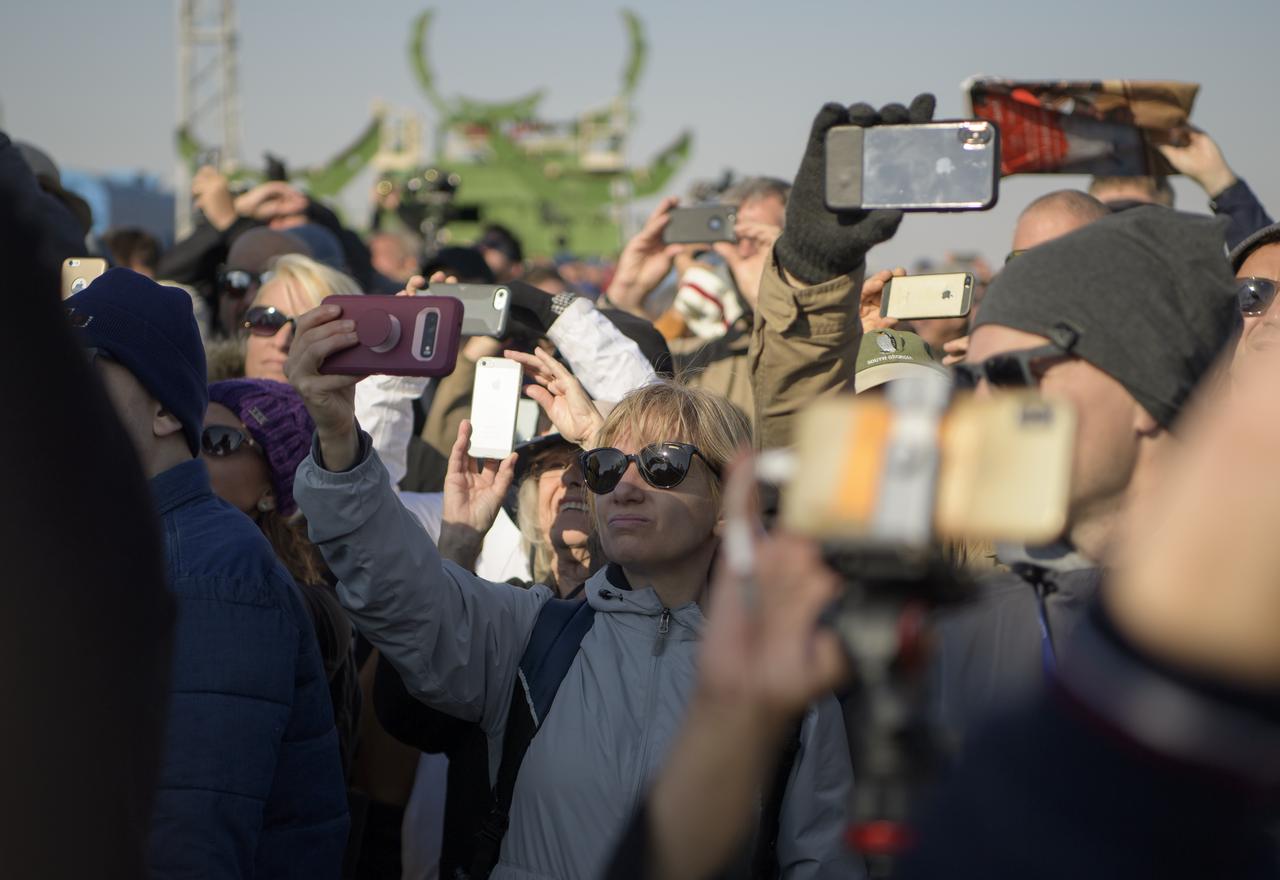 Guests watch as the Soyuz rocket is raised into vertical position on the launch pad, Monday, Sept. 23, 2019 at the Baikonur Cosmodrome in Kazakhstan. Expedition 61 crewmembers Jessica Meir of NASA, Oleg Skripochka of Roscosmos, and spaceflight participant Hazzaa Ali Almansoori of the United Arab Emirates will launch September 25th on the Soyuz MS-15 spacecraft from the Baikonur Cosmodrome to the International Space Station. Photo Credit: (NASA/Bill Ingalls)