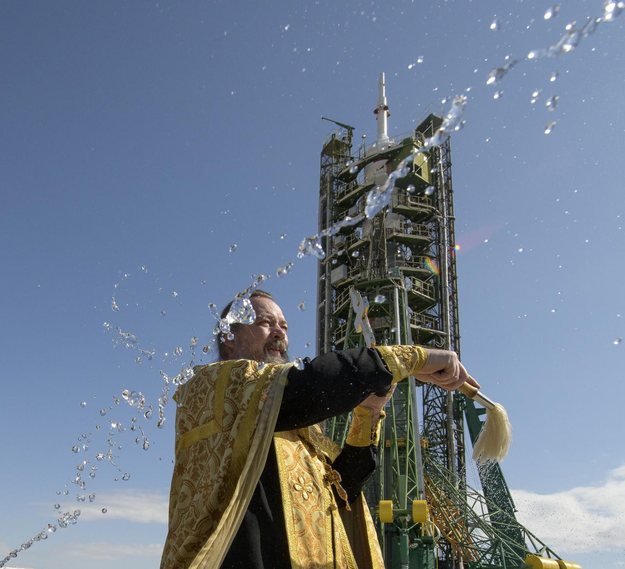 Russian Orthodox Priest Father Sergei blesses the Soyuz rocket and members of the media at the Baikonur Cosmodrome launch pad, Tuesday, Sept. 24, 2019 in Baikonur, Kazakhstan. Expedition 61 crew members Jessica Meir of NASA and Oleg Skripochka of Roscosmos, and spaceflight participant Hazzaa Ali Almansoori of the United Arab Emirates will launch September 25th on the Soyuz MS-15 spacecraft from the Baikonur Cosmodrome to the International Space Station. Photo Credit: (NASA/Bill Ingalls)