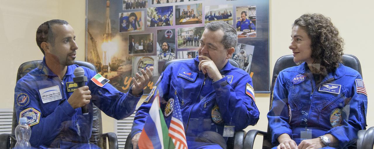 Spaceflight participant Hazzaa Ali Almansoori of the United Arab Emirates, left, and Expedition 61 prime crew members Oleg Skripochka of Roscosmos and Jessica Meir of NASA participate in a crew press conference, Tuesday, Sept. 24, 2019 at the Cosmonaut Hotel in Baikonur, Kazakhstan. Meir, Skripochka, and Almansoori will launch September 25th on the Soyuz MS-15 spacecraft from the Baikonur Cosmodrome to the International Space Station. Photo Credit: (NASA/Bill Ingalls)