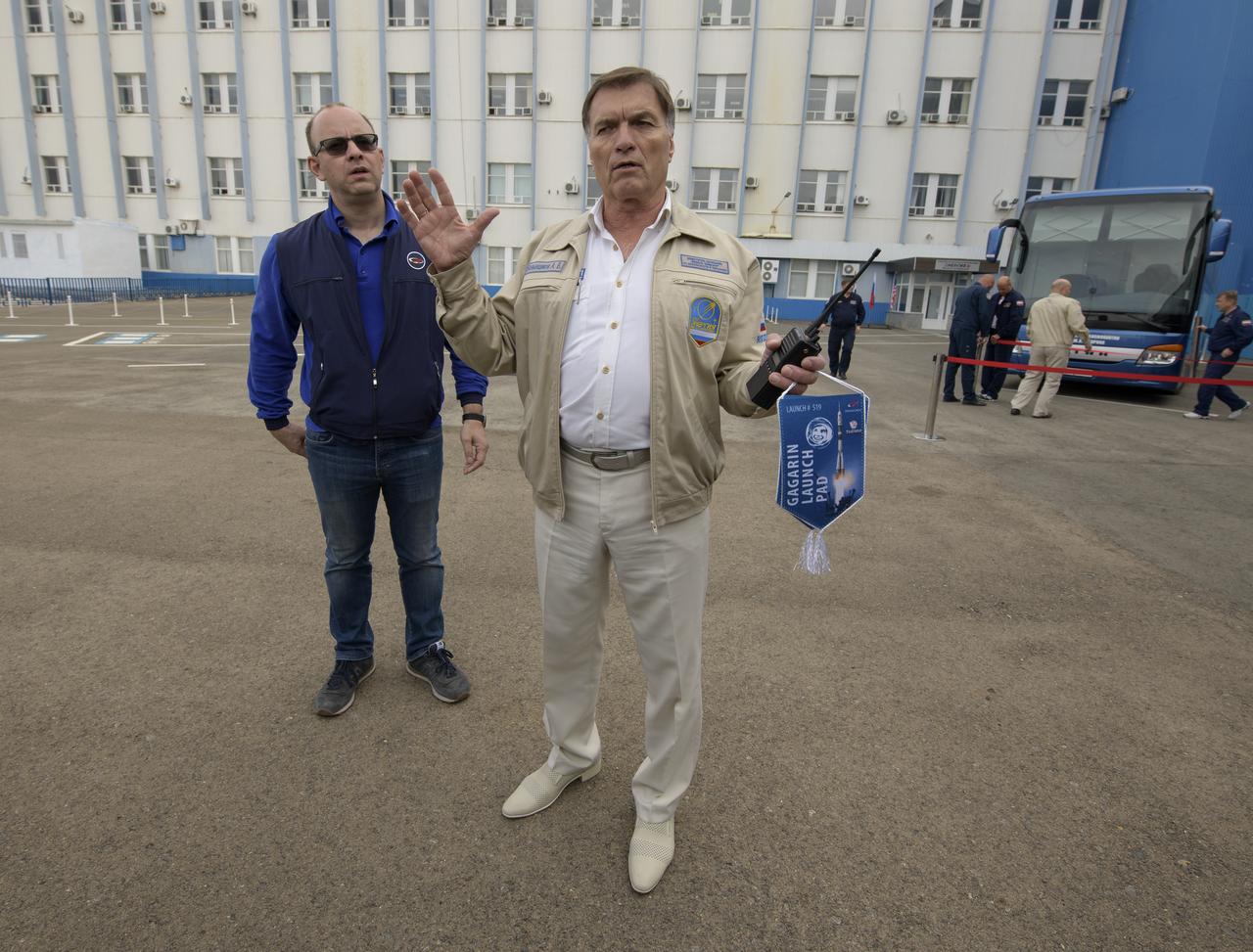 Security and media escorts explain the process of covering Expedition 61 crewmembers Jessica Meir of NASA and Oleg Skripochka of Roscosmos, and spaceflight participant Hazzaa Ali Almansoori of the United Arab Emirates as they have their Sokol suits pressure checked a few hours ahead of their launch on a Soyuz rocket, Wednesday, Sept. 25, 2019 at the Baikonur Cosmodrome in Kazakhstan. Meir, Skripochka, and Almansoori will launch on the Soyuz MS-15 spacecraft from the Baikonur Cosmodrome to the International Space Station. Photo Credit: (NASA/Bill Ingalls)