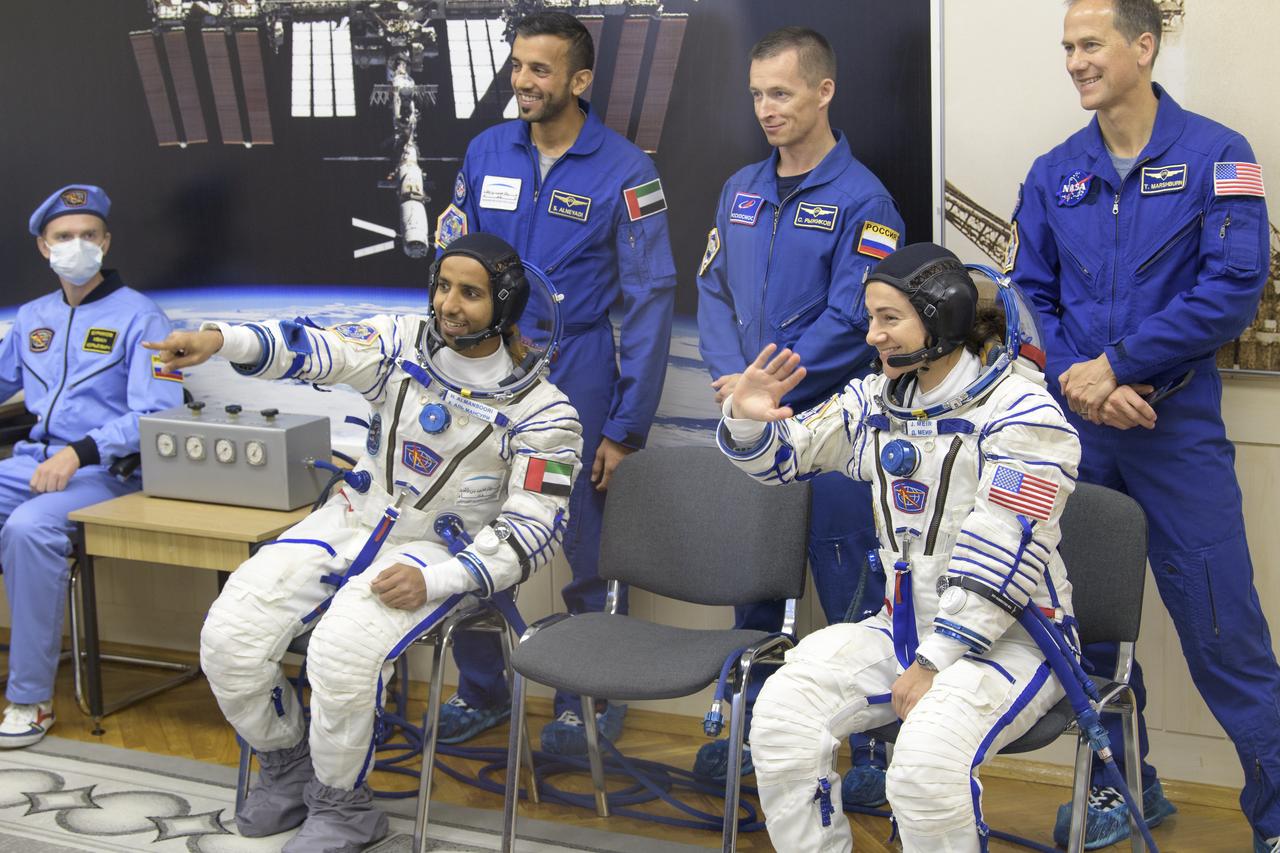 spaceflight participant Hazzaa Ali Almansoori of the United Arab Emirates, lower left, and Expedition 61 astronaut Jessica Meir of NASA wait to have their Sokol suits pressure checked a few hours ahead of their launch on a Soyuz rocket with Expedition 61 cosmonaut Oleg Skripochka of Roscosmos, Wednesday, Sept. 25, 2019 at the Baikonur Cosmodrome in Kazakhstan. Meir, Skripochka, and Almansoori will launch on the Soyuz MS-15 spacecraft from the Baikonur Cosmodrome to the International Space Station. Photo Credit: (NASA/Bill Ingalls)