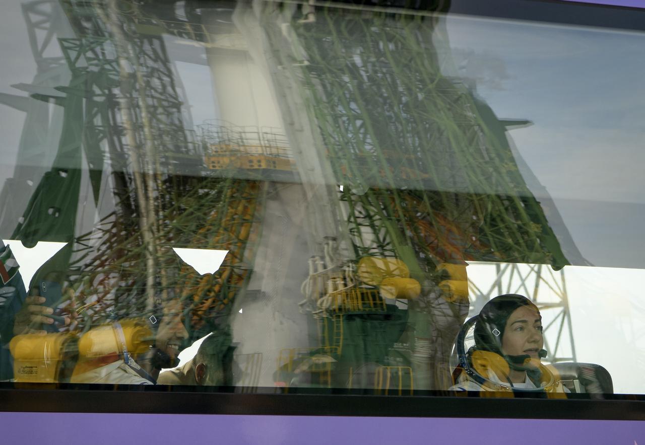 Spaceflight participant Hazzaa Ali Almansoori of the United Arab Emirates, left, and Expedition 61 astronaut Jessica Meir of NASA look at the Soyuz rocket as the bus carrying them and Expedition 61 cosmonaut Oleg Skripochka of Roscosmos arrives at the launch pad, Wednesday, Sept. 25, 2019 at the Baikonur Cosmodrome in Kazakhstan. Meir, Skripochka, and Almansoori will launch from the Baikonur Cosmodrome to the International Space Station. Photo Credit: (NASA/Bill Ingalls)