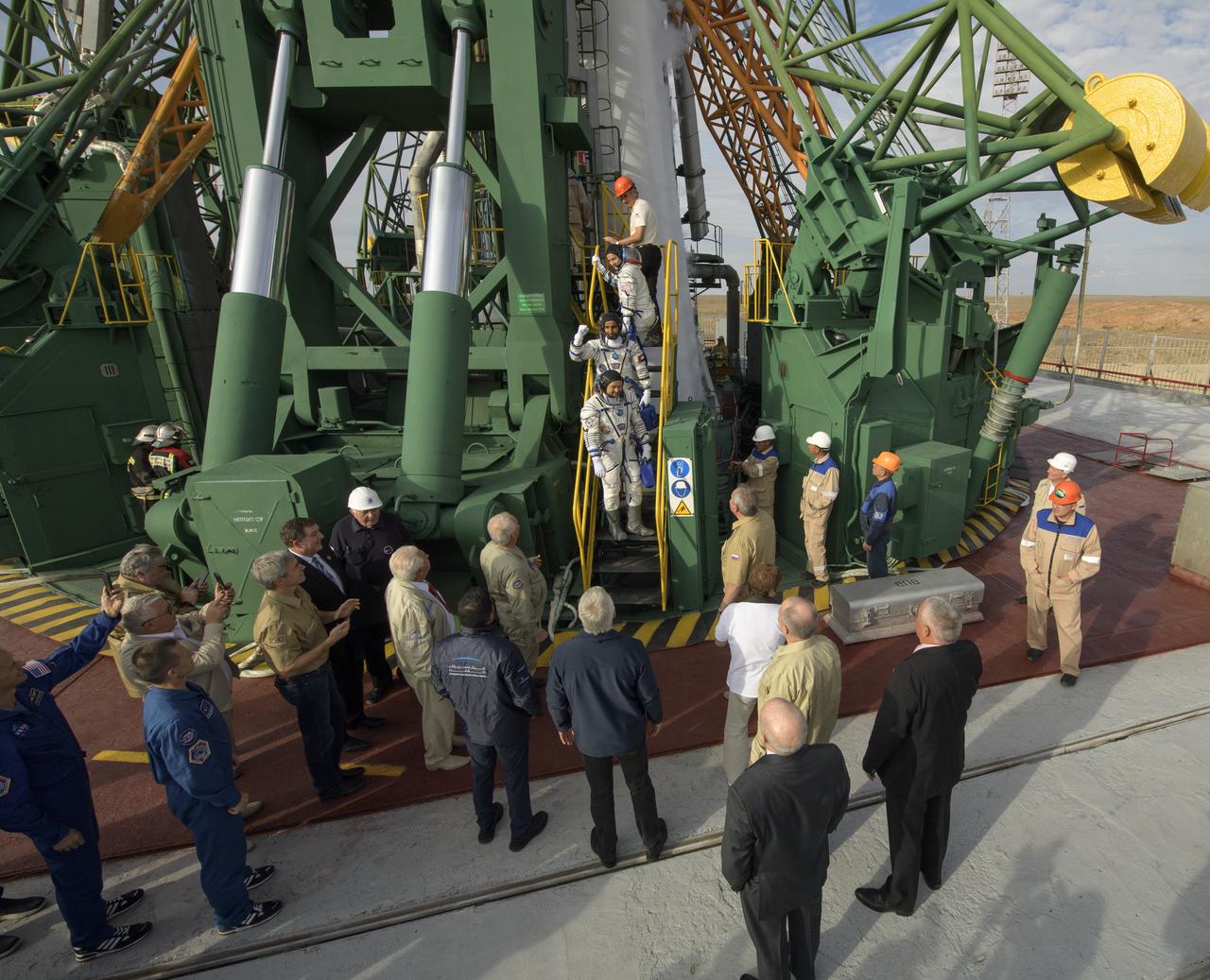 Expedition 61 astronaut Jessica Meir of NASA, top, spaceflight participant Hazzaa Ali Almansoori of the United Arab Emirates, center, and Expedition 61 cosmonaut Oleg Skripochka of Roscosmos, wave farewell prior to boarding the Soyuz MS-15 spacecraft for launch, Wednesday, Sept. 25, 2019 at the Baikonur Cosmodrome in Kazakhstan. Meir, Skripochka, and Almansoori will launch from the Baikonur Cosmodrome to the International Space Station. Photo Credit: (NASA/Bill Ingalls)
