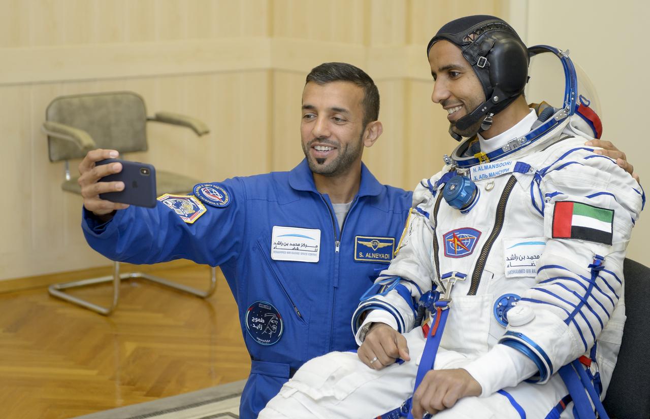 spaceflight participant Hazzaa Ali Almansoori of the United Arab Emirates and backup spaceflight participant Sultan Al-Neyadi take a photograph a few hours ahead of Almansoori’s launch on a Soyuz rocket with Expedition 61 crewmembers Jessica Meir of NASA and Oleg Skripochka of Roscosmos, Wednesday, Sept. 25, 2019 at the Baikonur Cosmodrome in Kazakhstan. Meir, Skripochka, and Almansoori will launch on the Soyuz MS-15 spacecraft from the Baikonur Cosmodrome to the International Space Station. Photo Credit: (NASA/GCTC/Irina Spector)