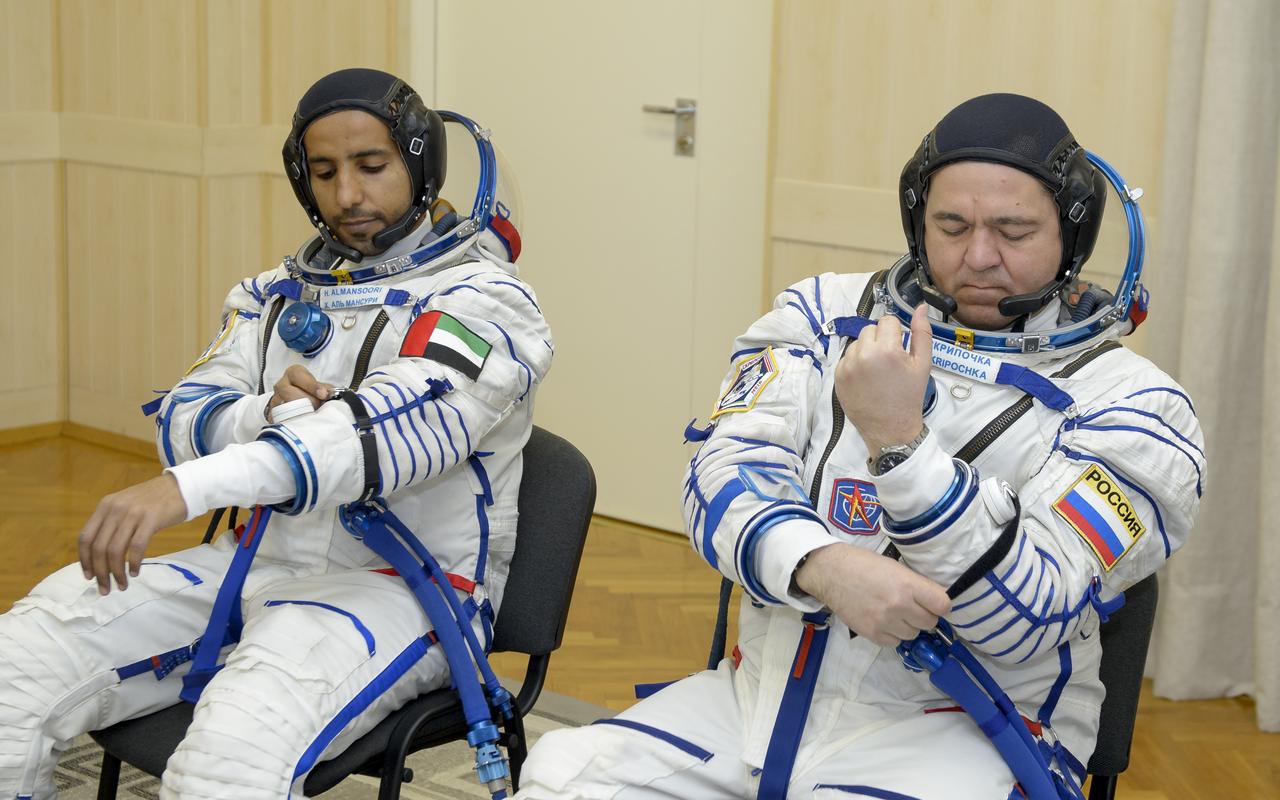 Spaceflight participant Hazzaa Ali Almansoori of the United Arab Emirates, left, and Expedition 61 cosmonaut Oleg Skripochka of Roscosmos don their Sokol suits a few hours ahead of their launch on a Soyuz rocket with Expedition 61 astronaut Jessica Meir of NASA, Wednesday, Sept. 25, 2019 at the Baikonur Cosmodrome in Kazakhstan. Meir, Skripochka, and Almansoori will launch on the Soyuz MS-15 spacecraft from the Baikonur Cosmodrome to the International Space Station. Photo Credit: (NASA/GCTC/Irina Spector)