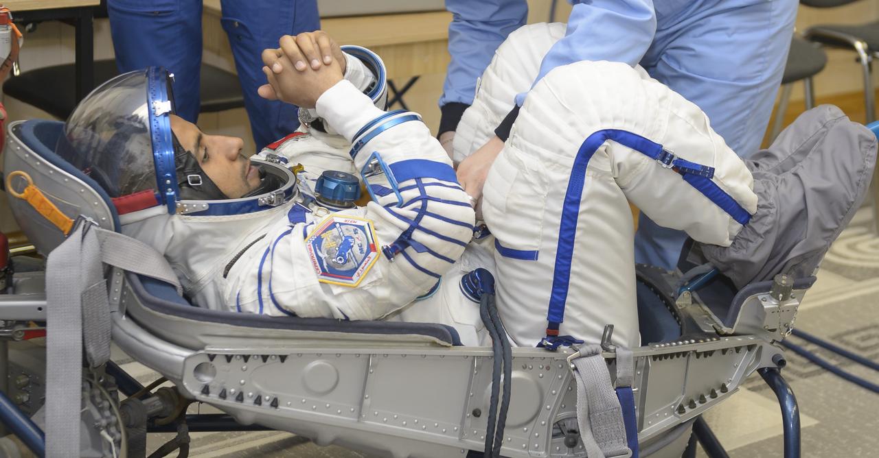 spaceflight participant Hazzaa Ali Almansoori of the United Arab Emirates has his Sokol Suit pressure checked a few hours ahead of his launch on a Soyuz rocket with Expedition 61 crewmembers Jessica Meir of NASA and Oleg Skripochka of Roscosmos, Wednesday, Sept. 25, 2019 at the Baikonur Cosmodrome in Kazakhstan. Meir, Skripochka, and Almansoori will launch on the Soyuz MS-15 spacecraft from the Baikonur Cosmodrome to the International Space Station. Photo Credit: (NASA/GCTC/Irina Spector)