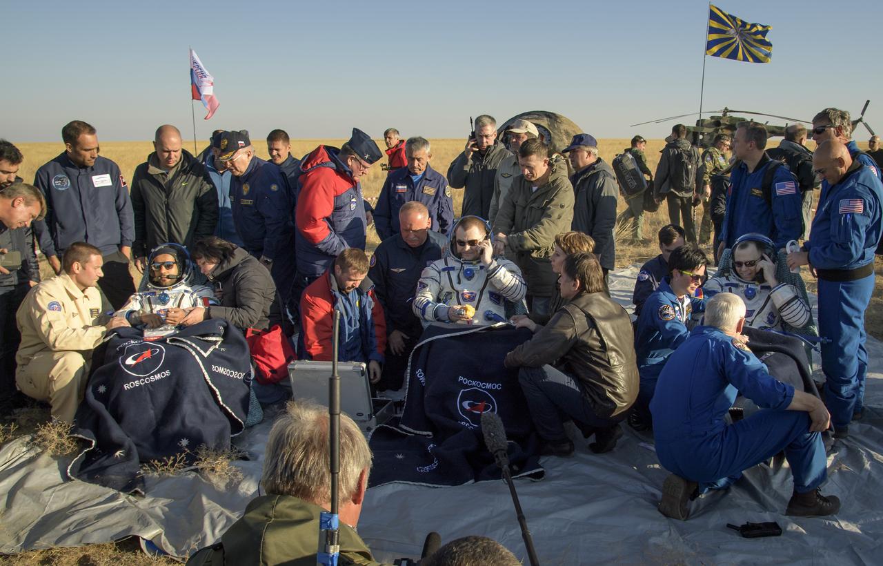 Visiting astronaut Hazzaa Ali Almansoori of the United Arab Emirates, left, Expedition 60 crewmembers Alexey Ovchinin of Roscosmos, center, and Nick Hague of NASA sit in chairs outside the Soyuz MS-12 spacecraft after they landed in a remote area near the town of Zhezkazgan, Kazakhstan on Thursday, Oct. 3, 2019. Hague and Ovchinin are returning after 203 days in space where they served as members of the Expedition 59 and 60 crews onboard the International Space Station. Almansoori logged 8 days in space during his first flight as an astronaut. Photo Credit: (NASA/Bill Ingalls)