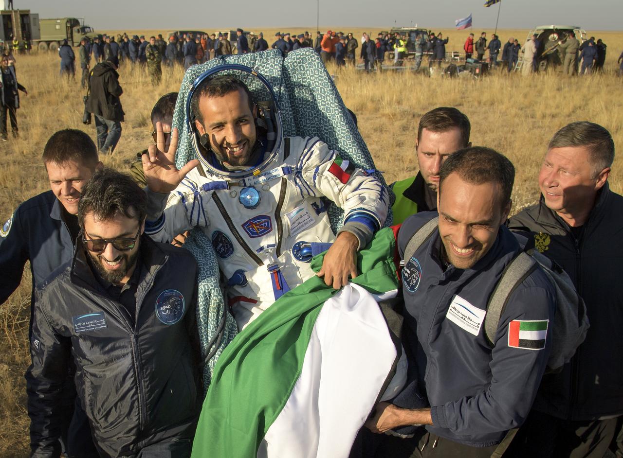 Visiting astronaut Hazzaa Ali Almansoori of the United Arab Emiratesis carried to a medical tent shortly after he and Expedition 60 crewmembers Alexey Ovchinin of Roscosmos and Nick Hague of NASA landed in their Soyuz MS-12 spacecraft near the town of Zhezkazgan, Kazakhstan on Thursday, Oct. 3, 2019. Hague and Ovchinin are returning after 203 days in space where they served as members of the Expedition 59 and 60 crews onboard the International Space Station. Almansoori logged 8 days in space during his first flight as an astronaut. Photo Credit: (NASA/Bill Ingalls)